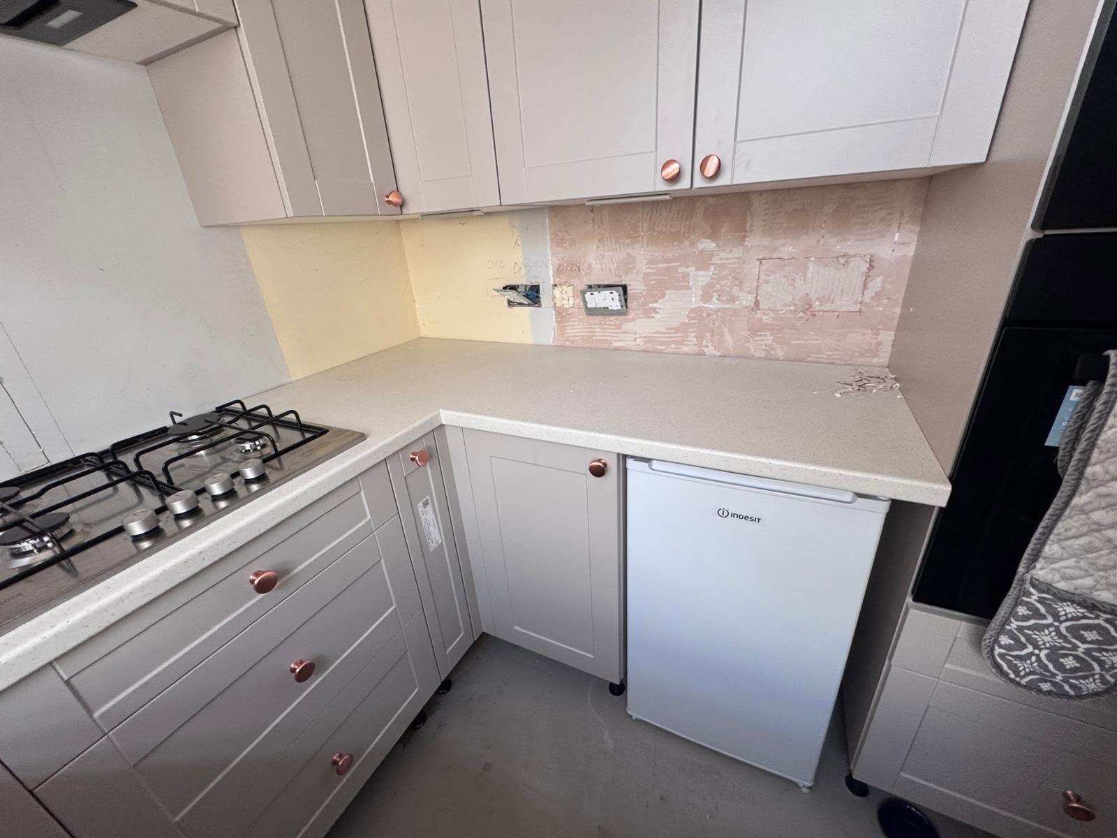 Corner of the kitchen showing patched plaster before tiling