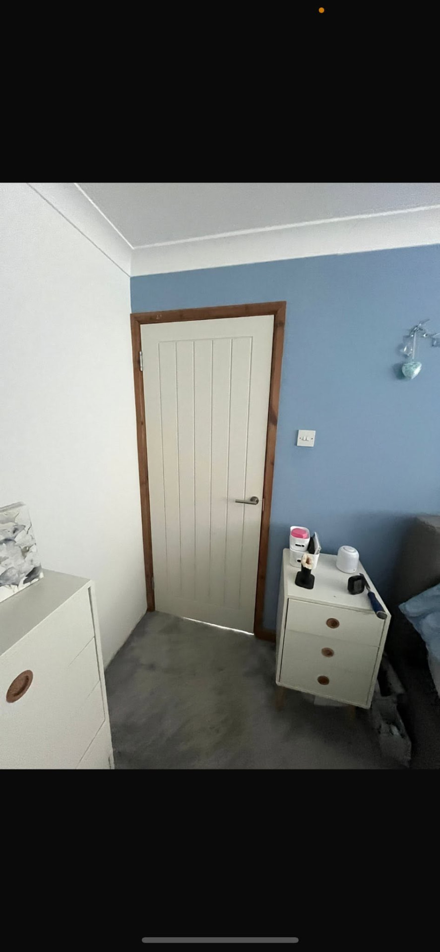 New white panelled bedroom door within its timber frame