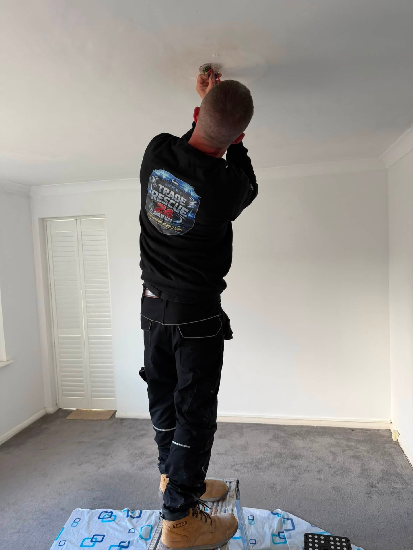 Trade Rescue 24/7 electrician testing a live ceiling connection before making it safe