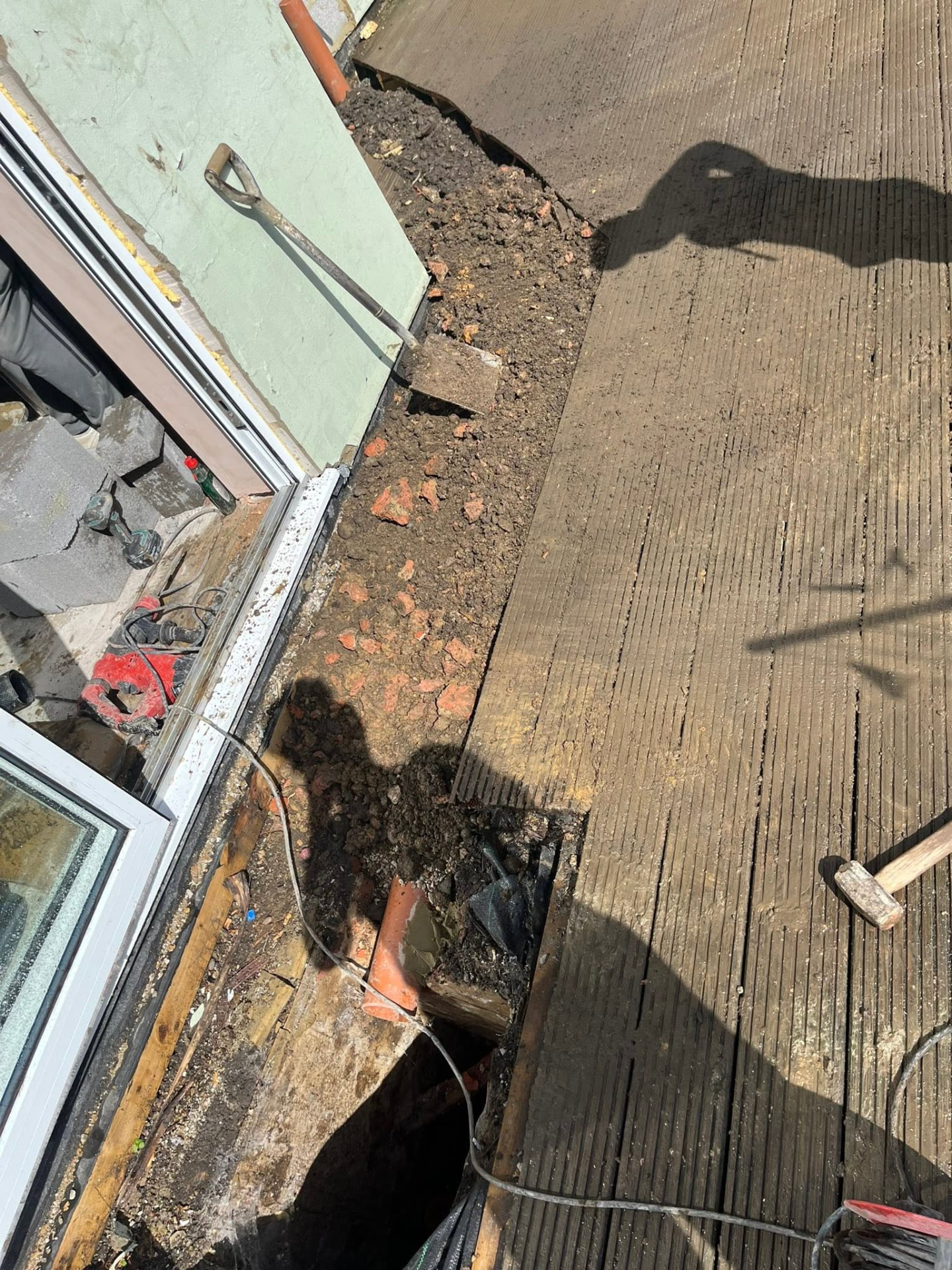 Drainage run completed and the trench backfilled alongside the property
