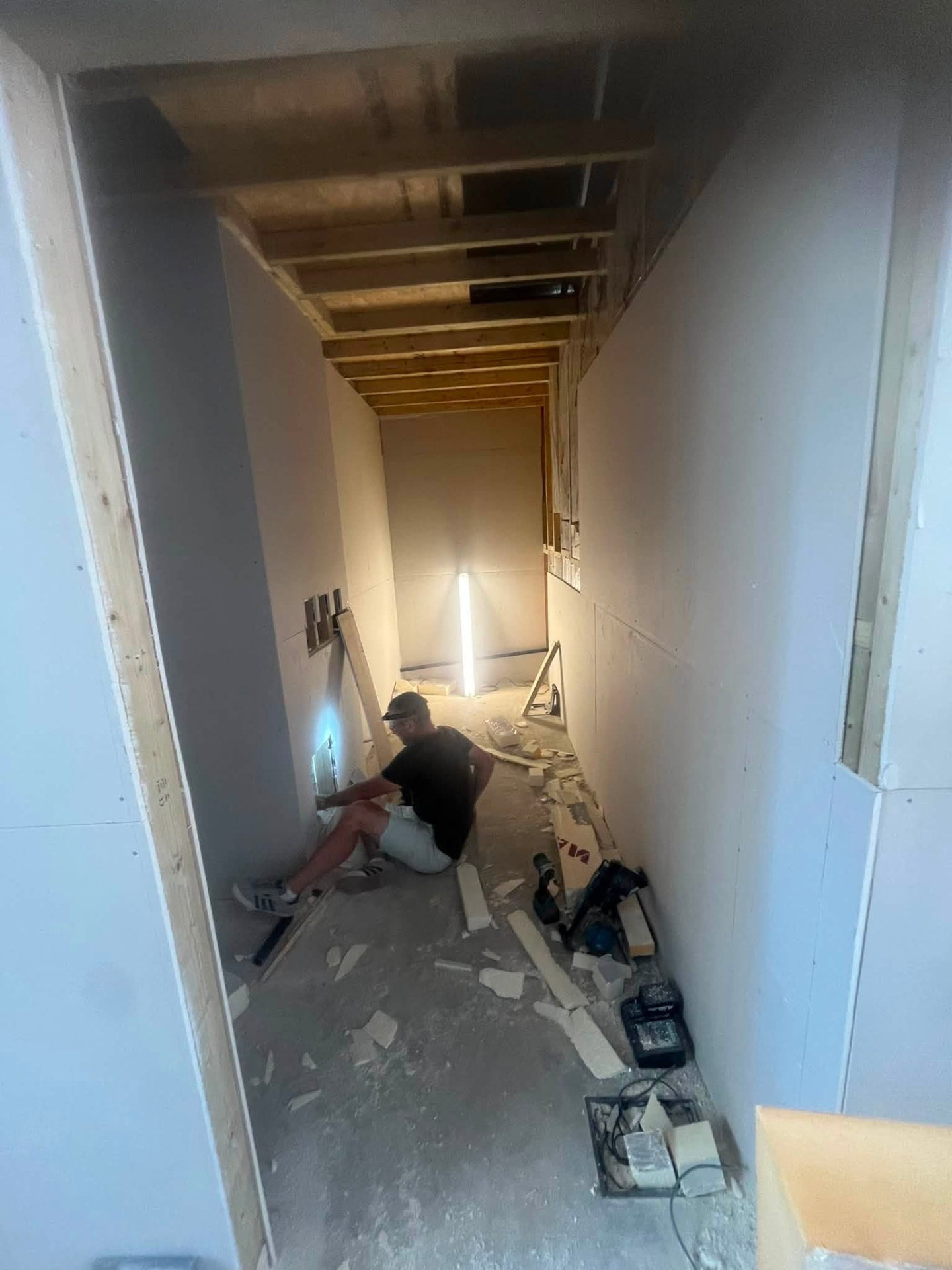 Carpenter fitting out the boarded corridor during the pub refurbishment