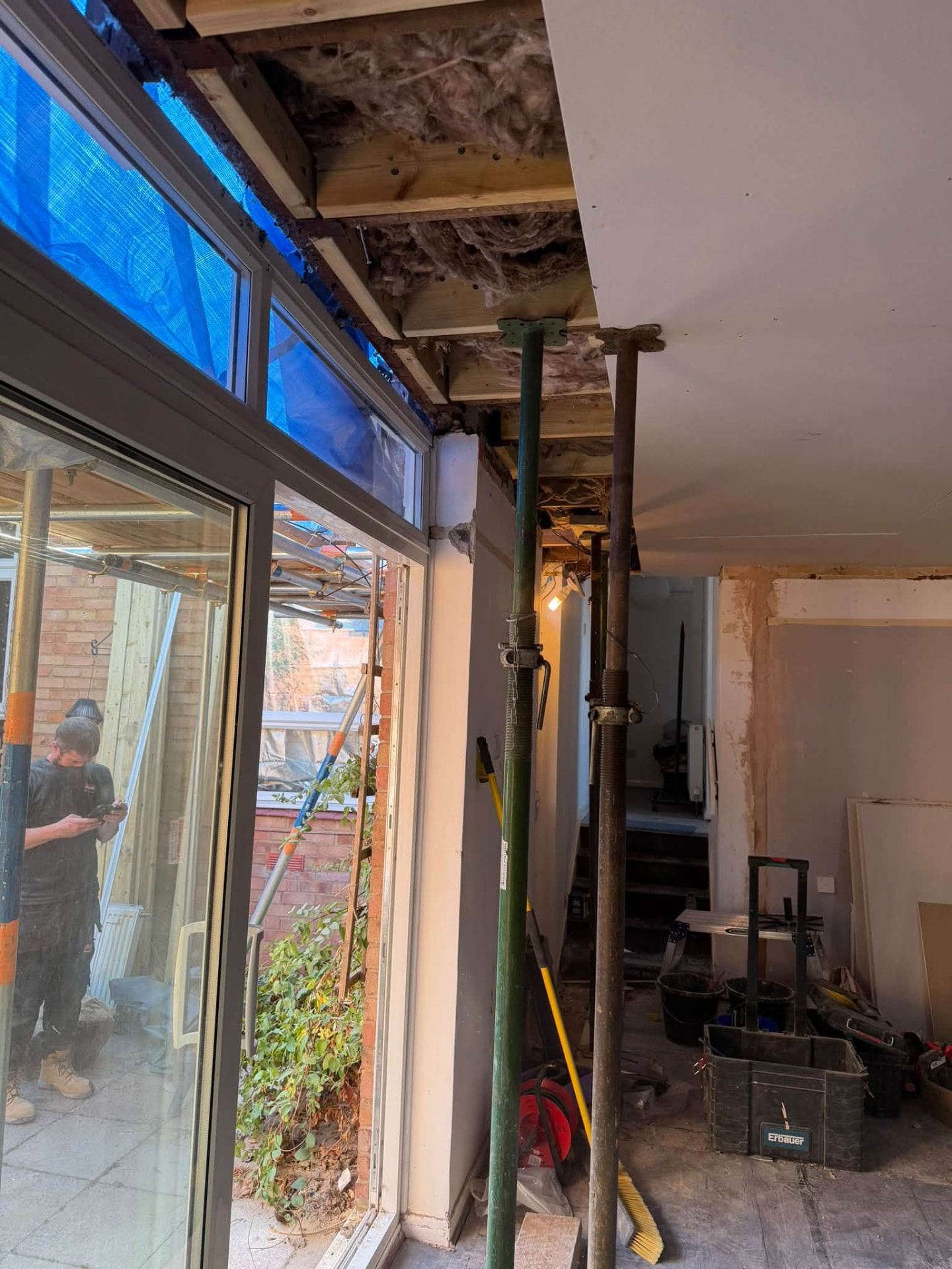 Acrow props supporting the structure beside new bi-fold door framing