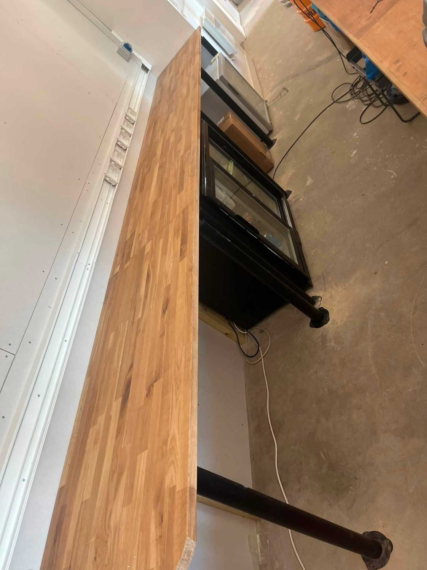 Finished oak bar counter running the length of the servery