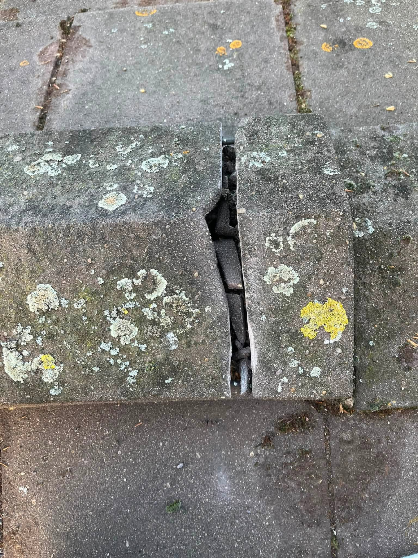 Cracked and open ridge tile joint with failed mortar bedding