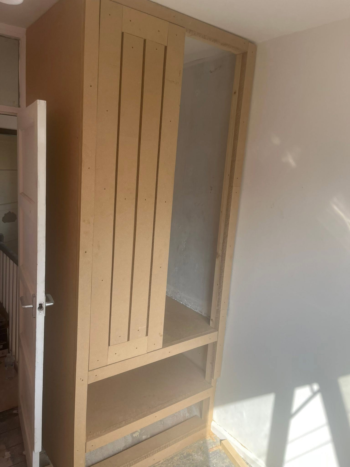 New MDF wardrobe carcass and shelving fitted into the alcove