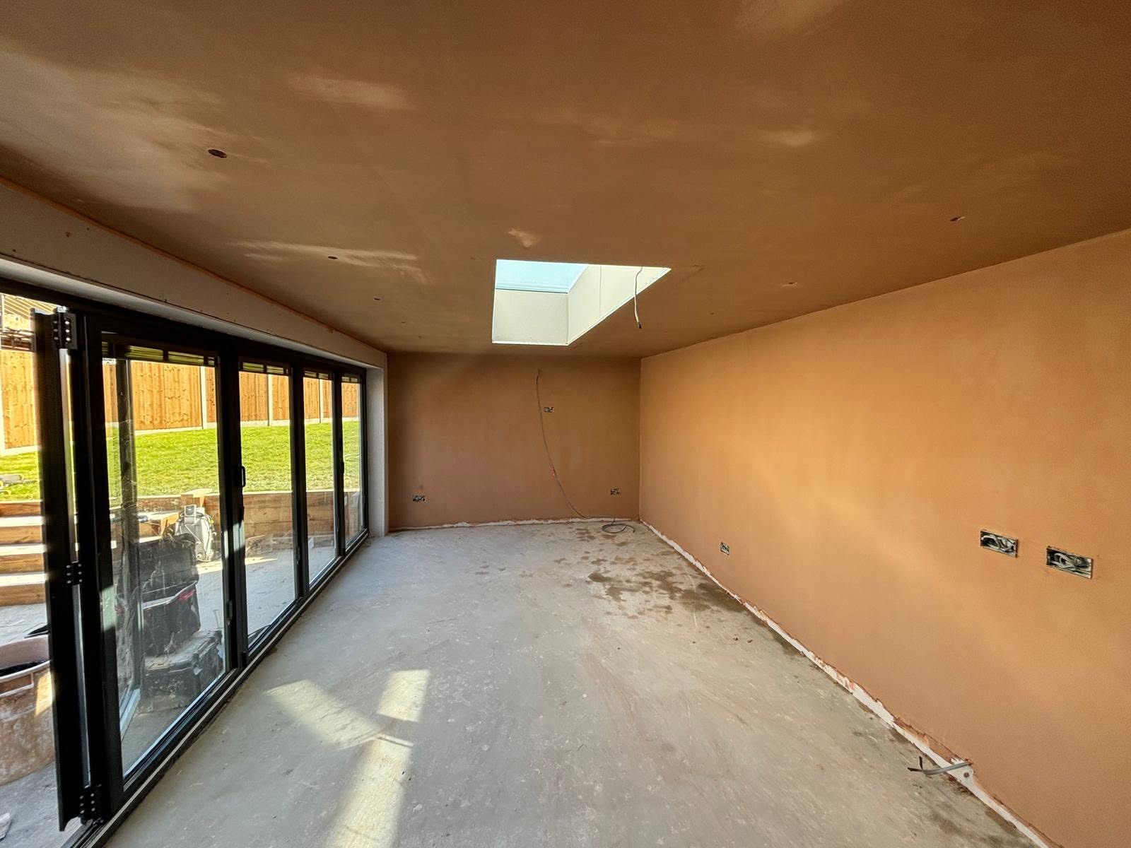Freshly plastered extension room with skimmed walls and ceiling and a new skylight