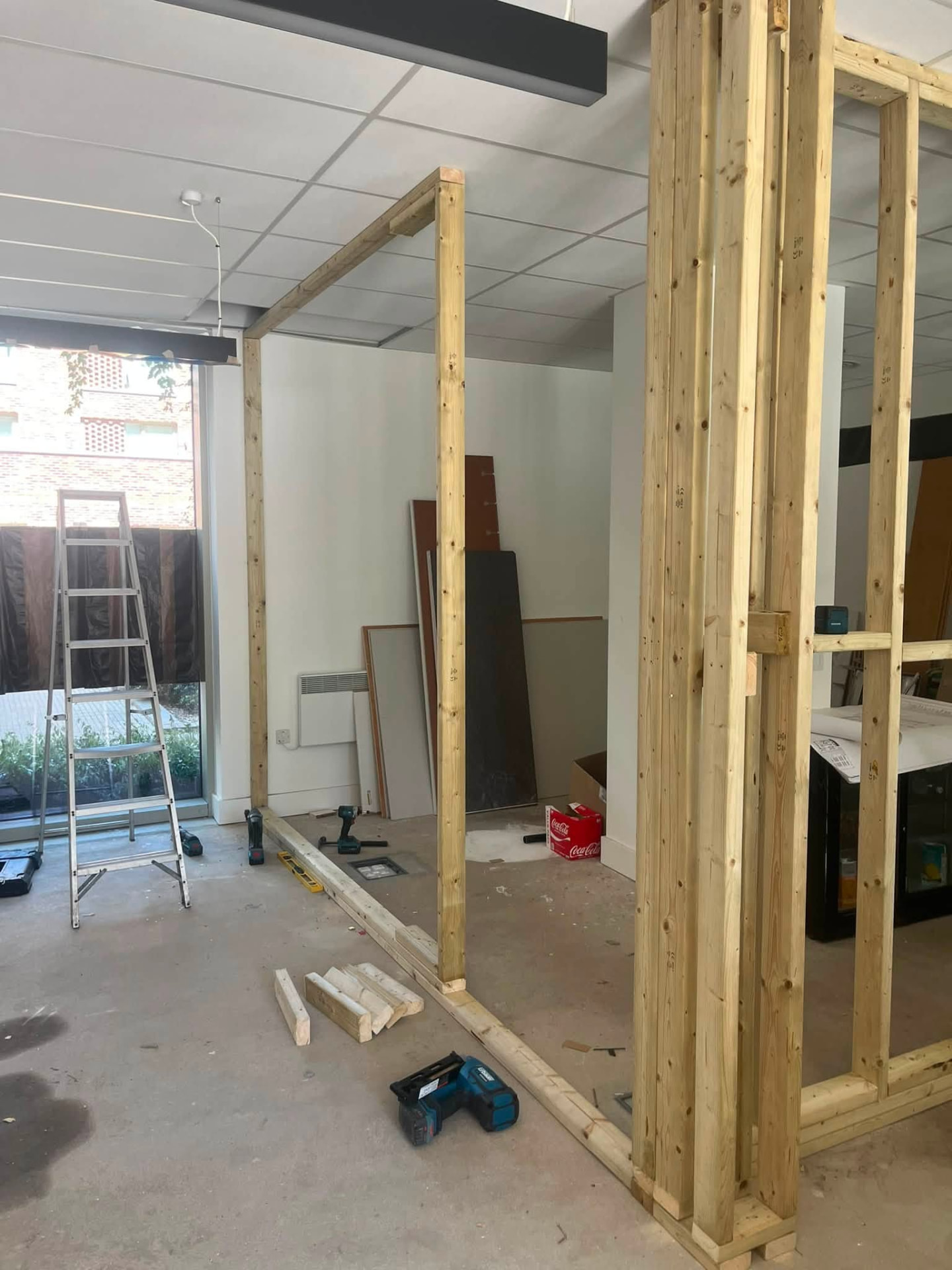 Partition frames meeting at a corner with doorway opening formed