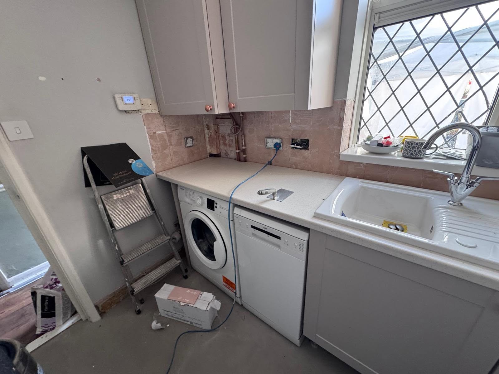 Utility side of the kitchen with untiled walls before works