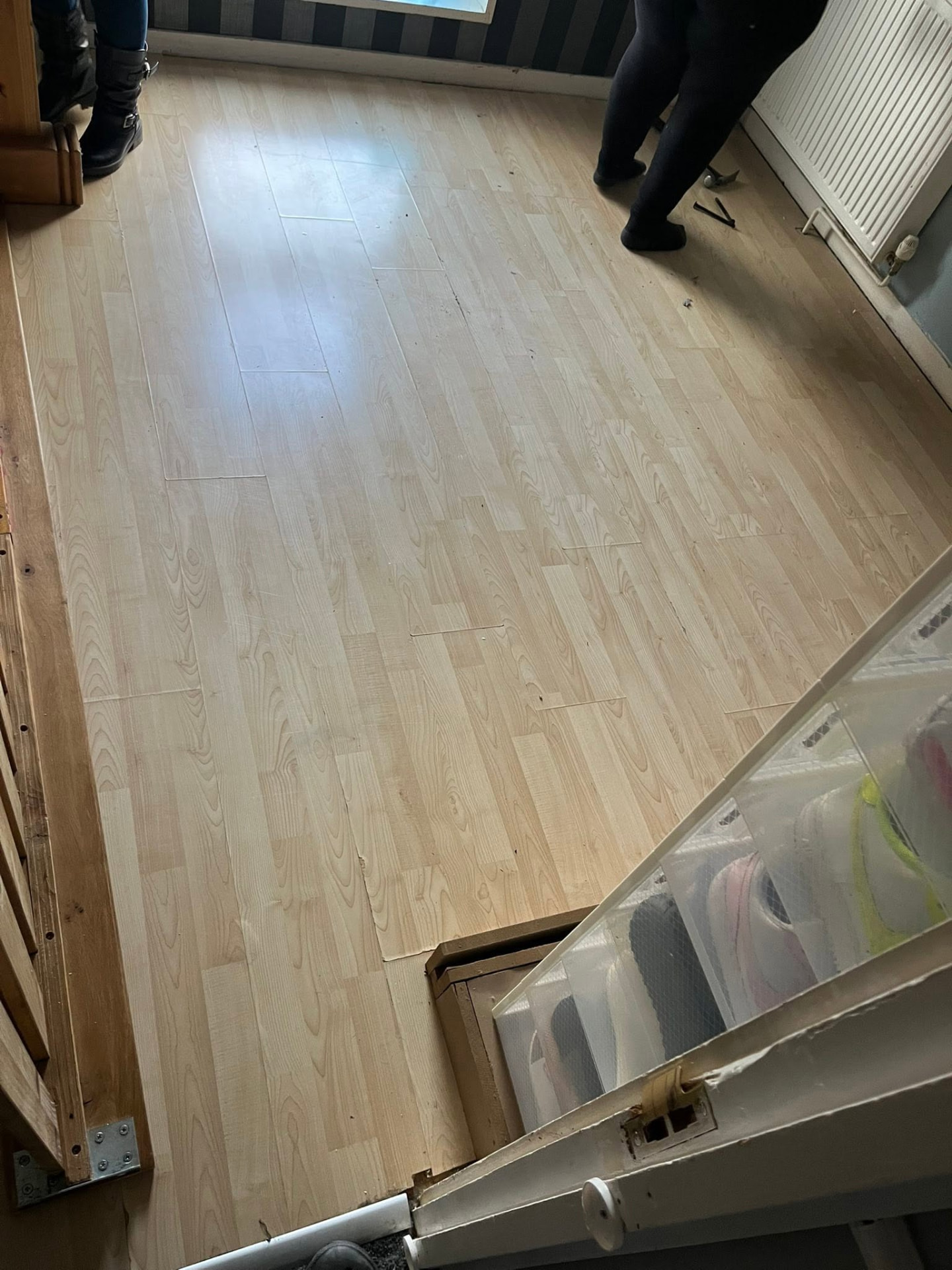 New light wood flooring being laid in the bedroom