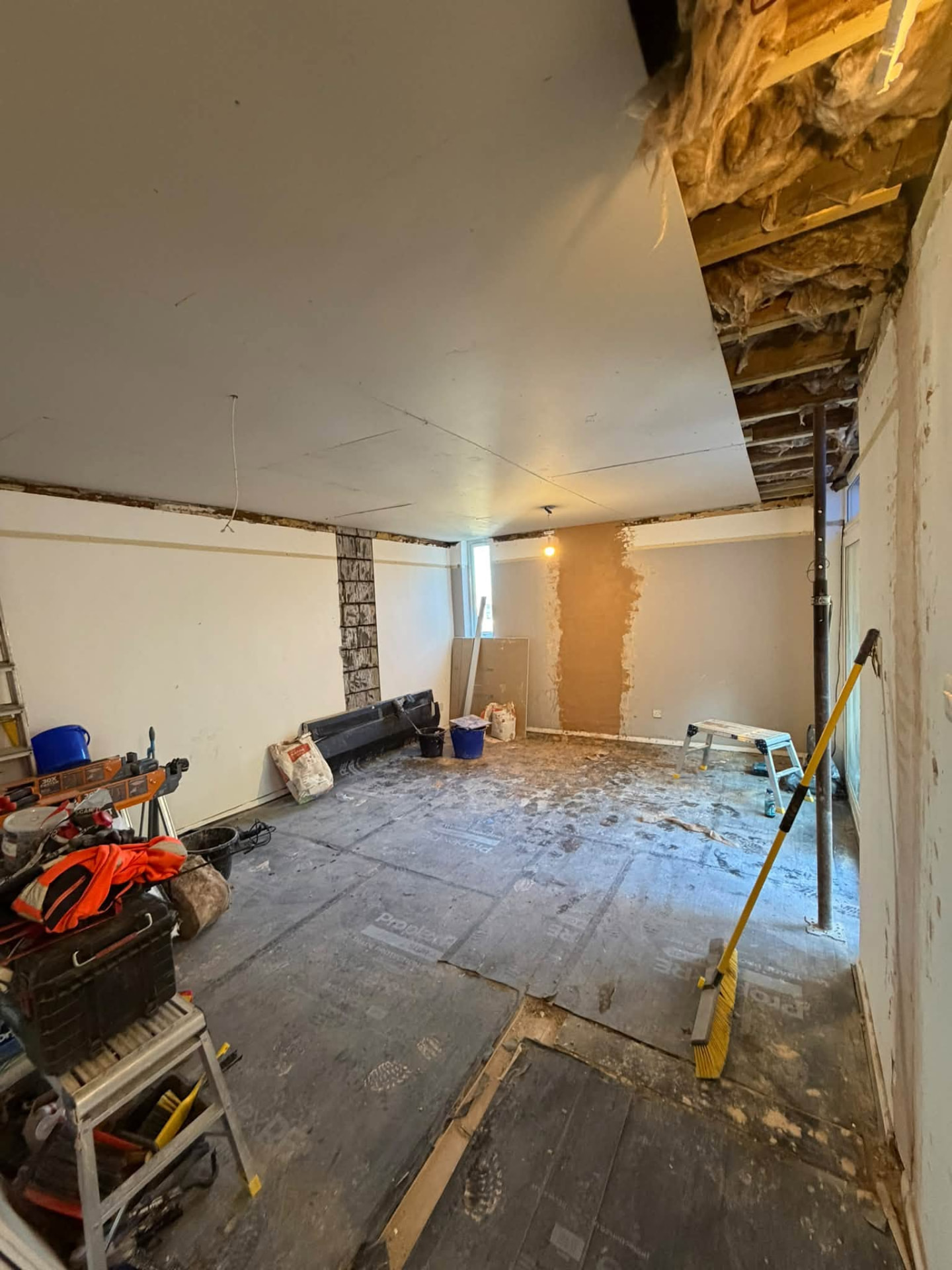 Interior room with new plasterboard ceiling and props still in place