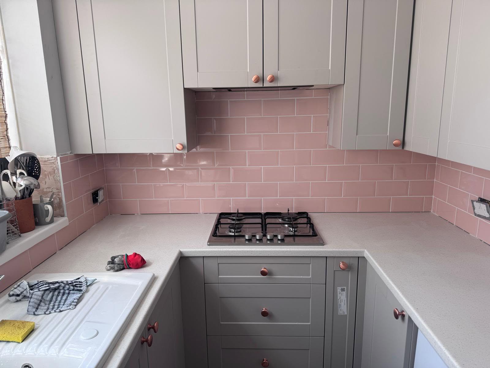 Blush pink subway tile splashback fitted behind the hob