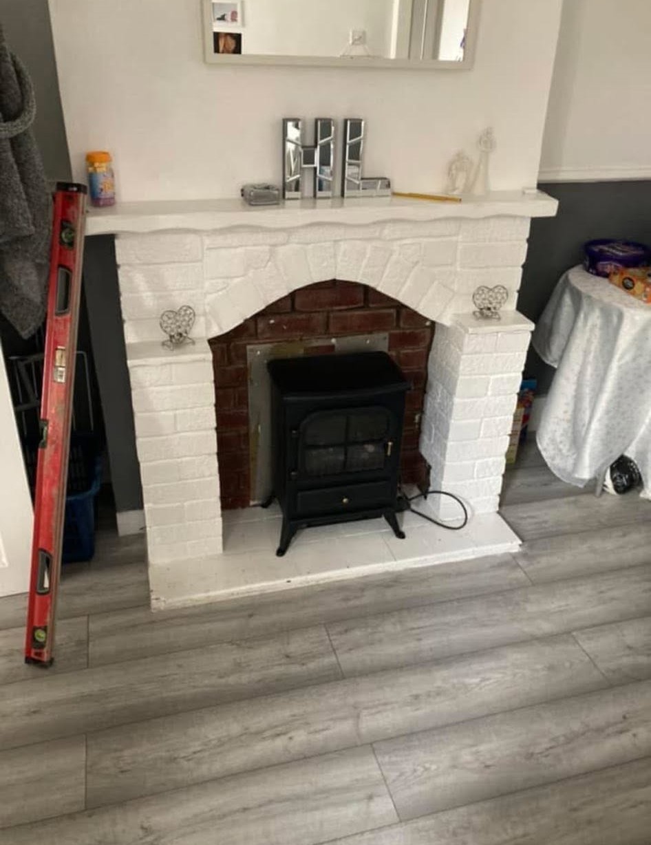 Completed modern white fireplace with square MDF cladding and log burner