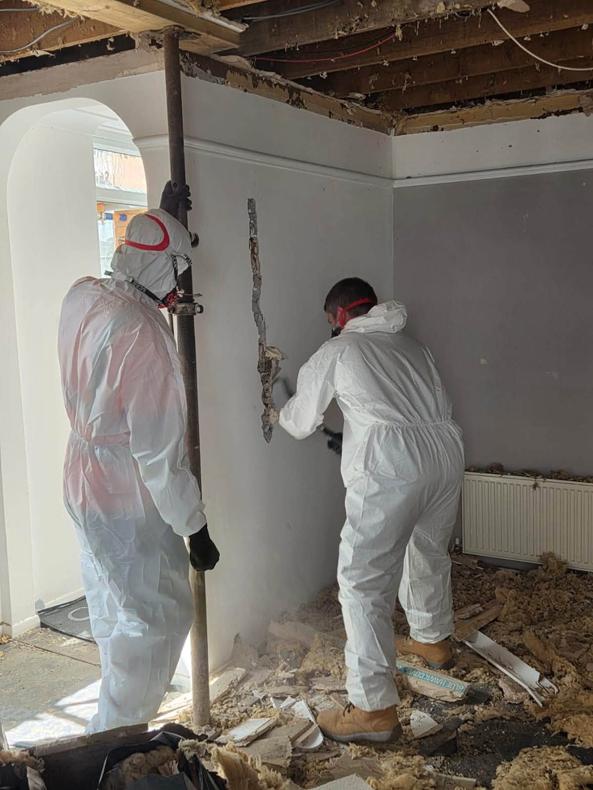 Team cutting away damaged wall sections during the structural repair