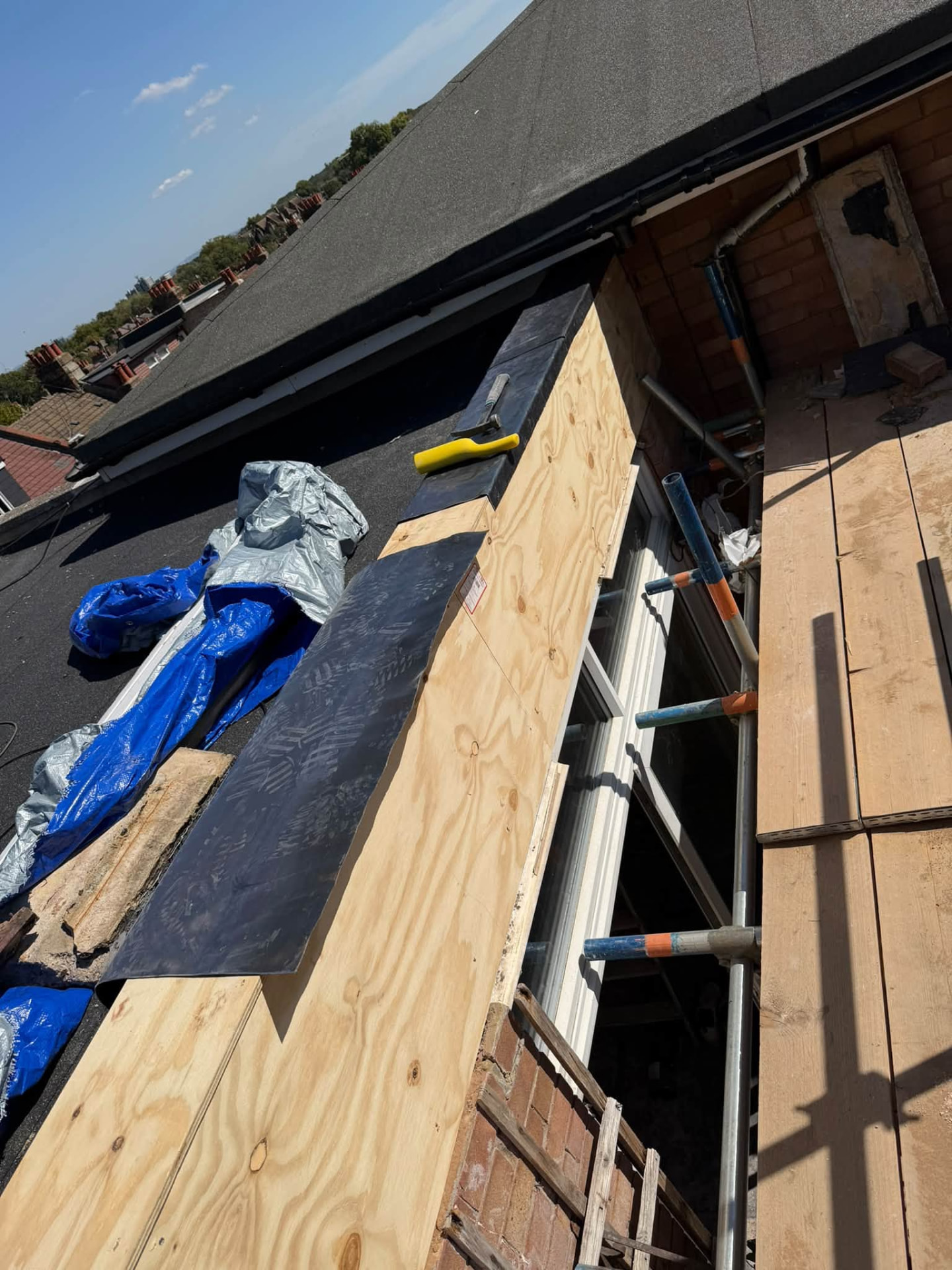 New lead flashing being formed along the newly clad roof edge