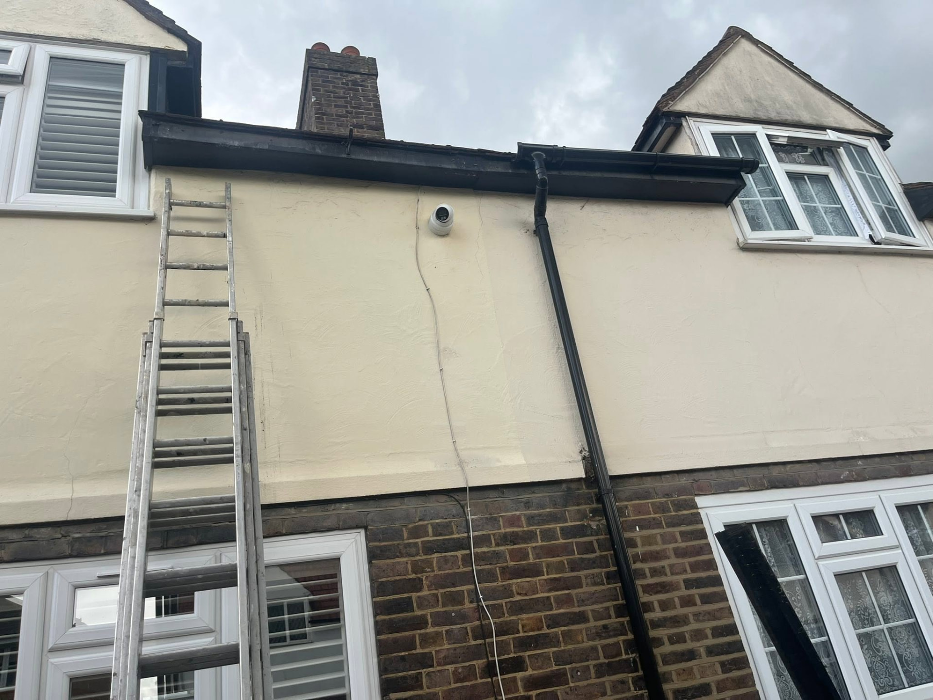 Ladder set up to the gutter line while the union seals and clip are replaced