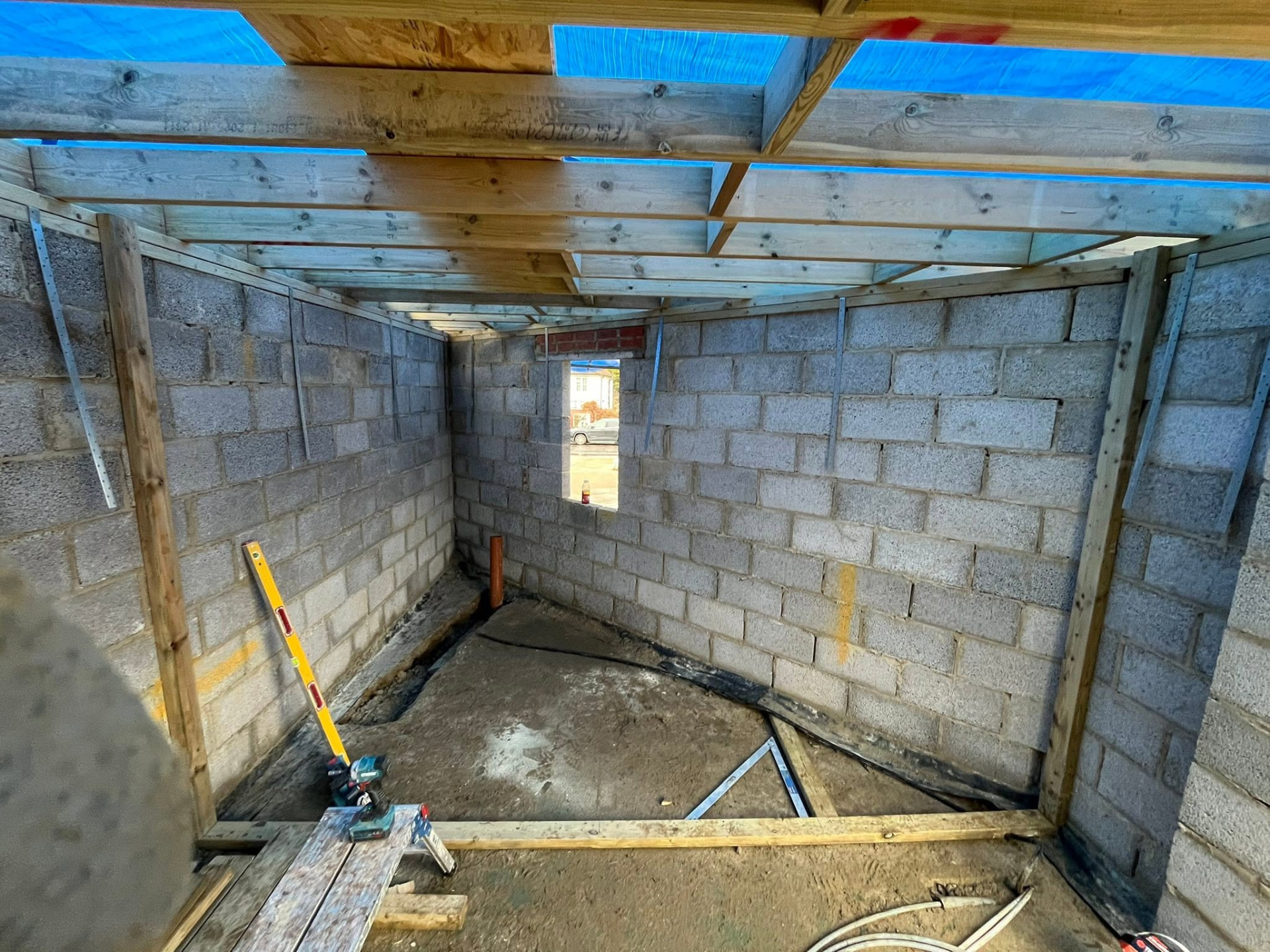 Interior view of the new build with roof joists and timber studwork