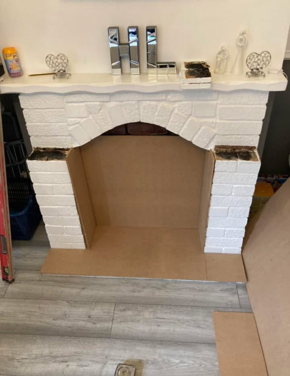 Fireplace surround part painted with the MDF cladding fitted