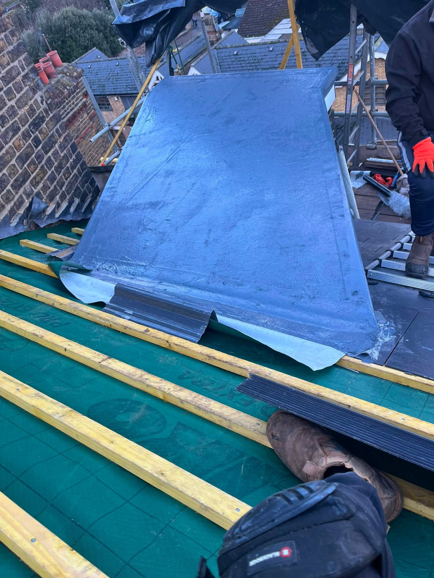 Lead flashing and battens fitted over breathable membrane on the roof slope