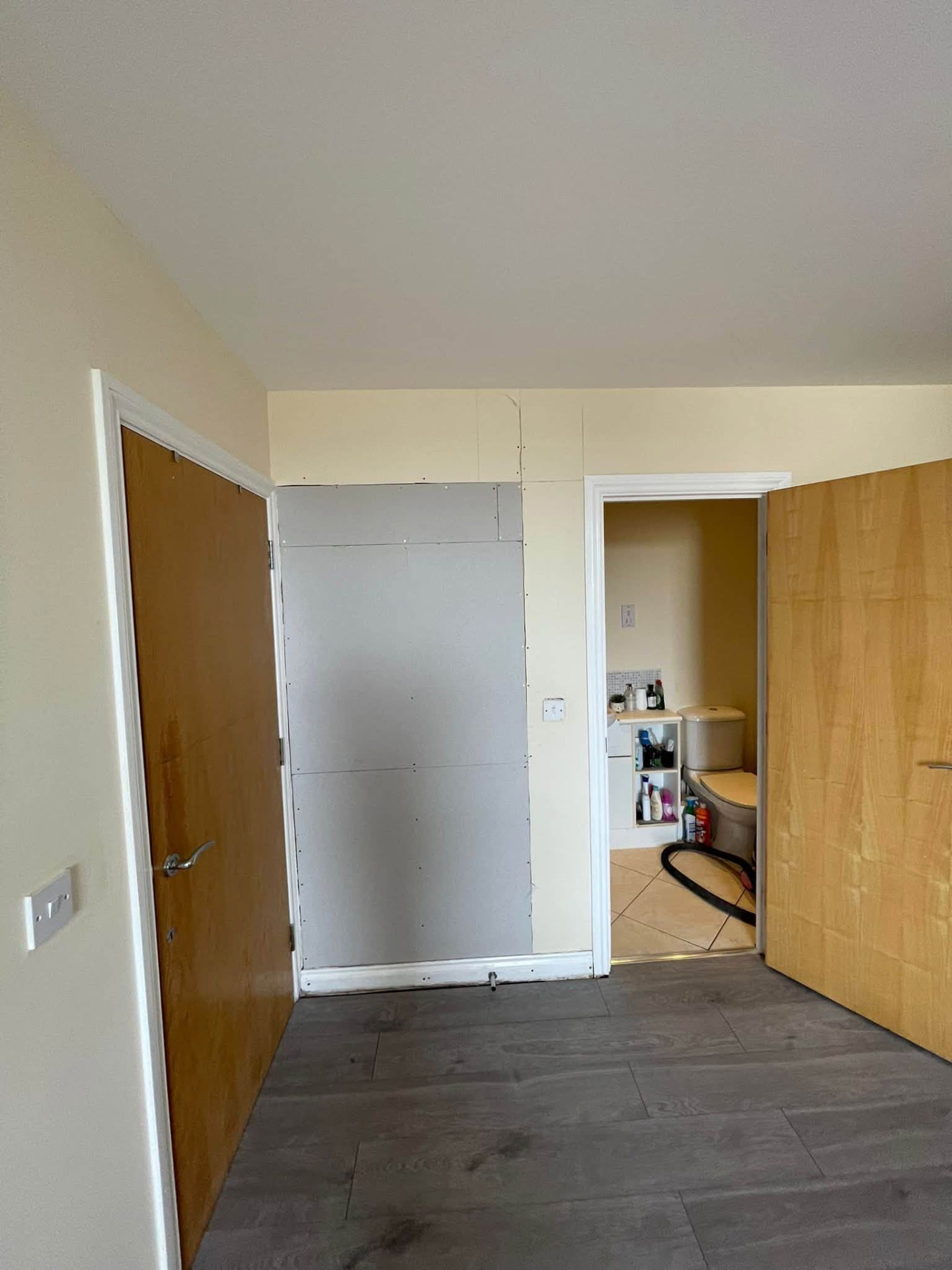 Rebuilt and boarded partition wall alongside the new laminate flooring