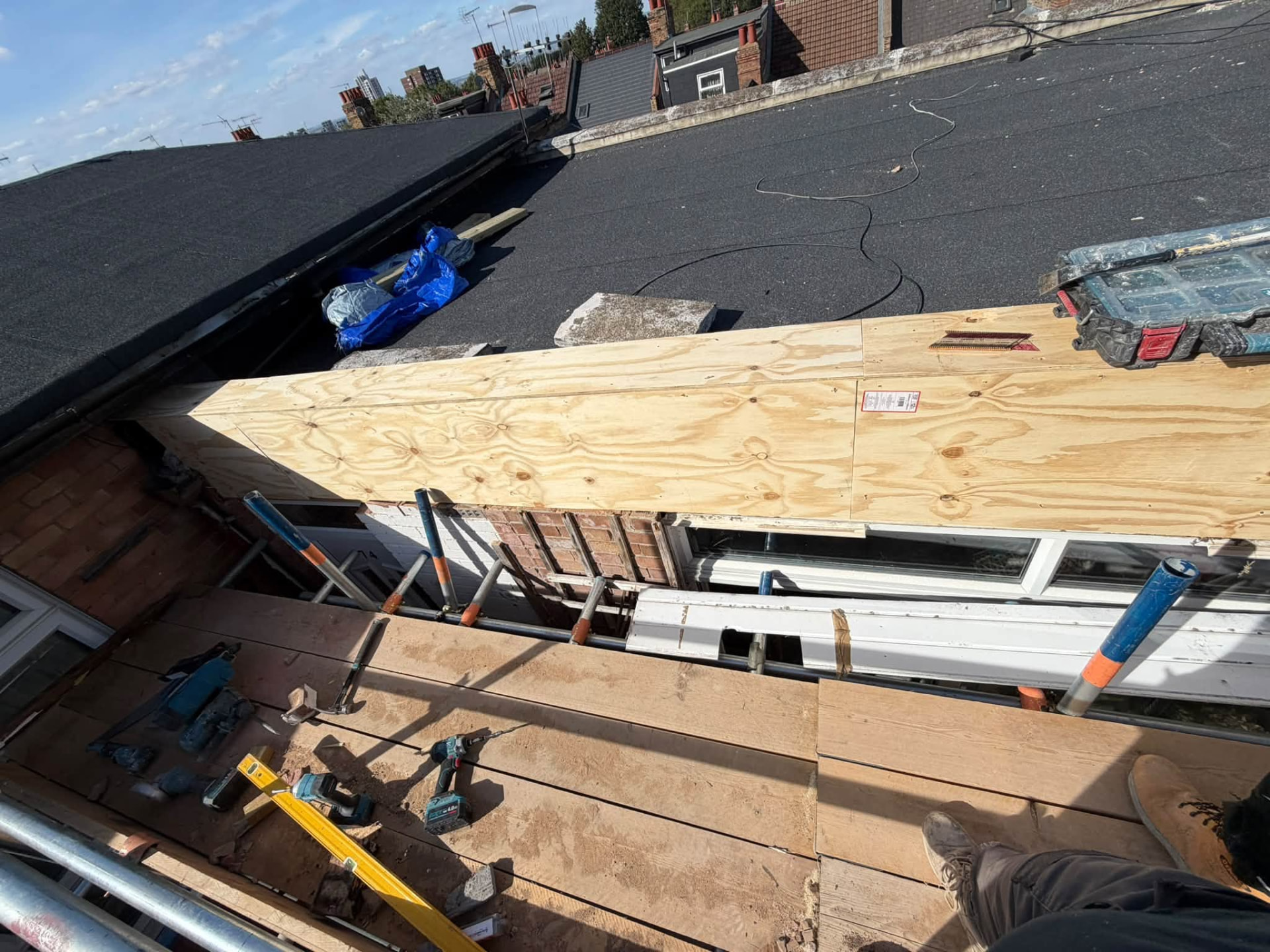 New plywood sheathing fixed across the rebuilt roof edge
