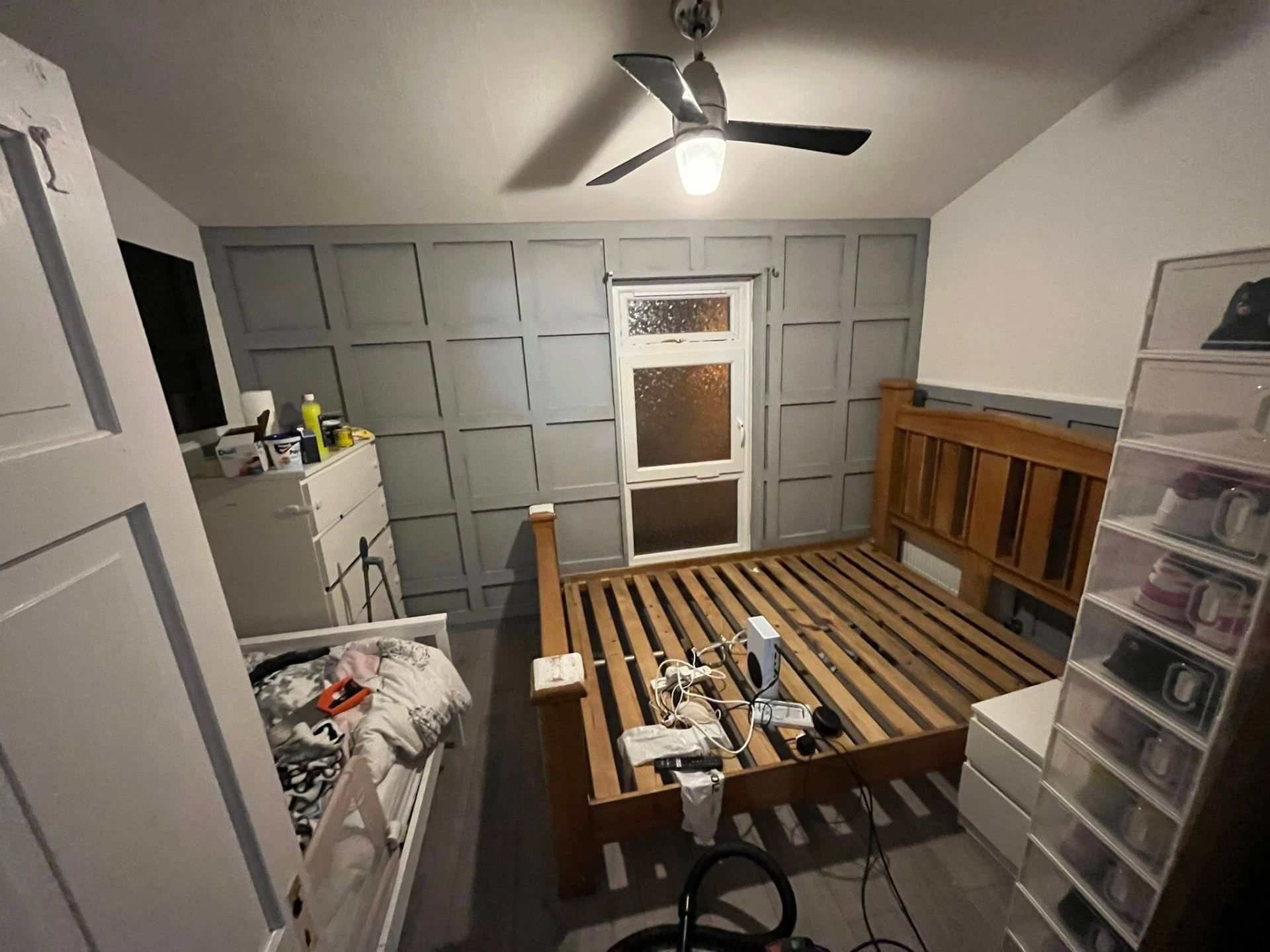 Completed full-wall panelling painted in soft grey