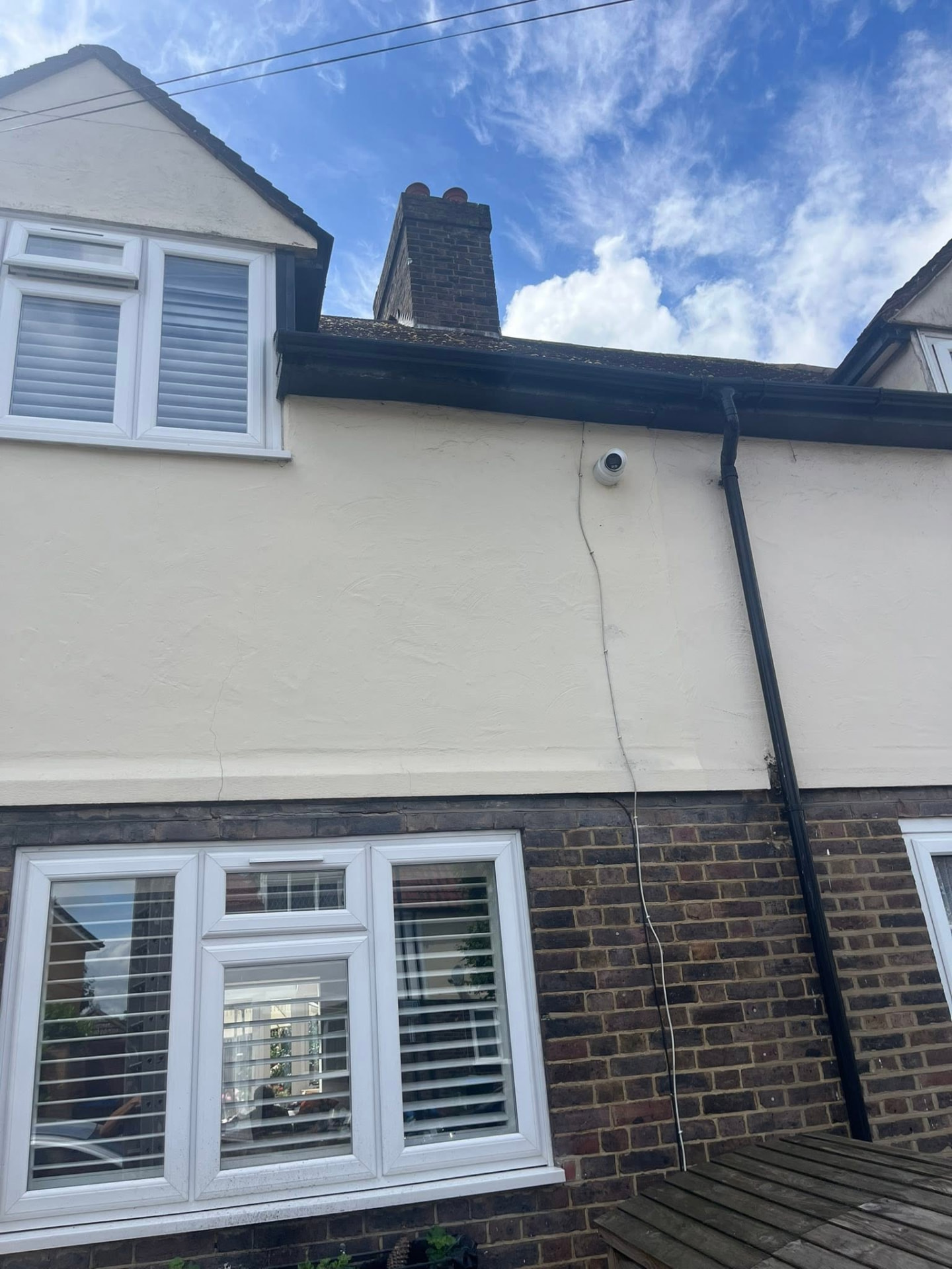Leaking gutter and downpipe on the rear elevation before repair
