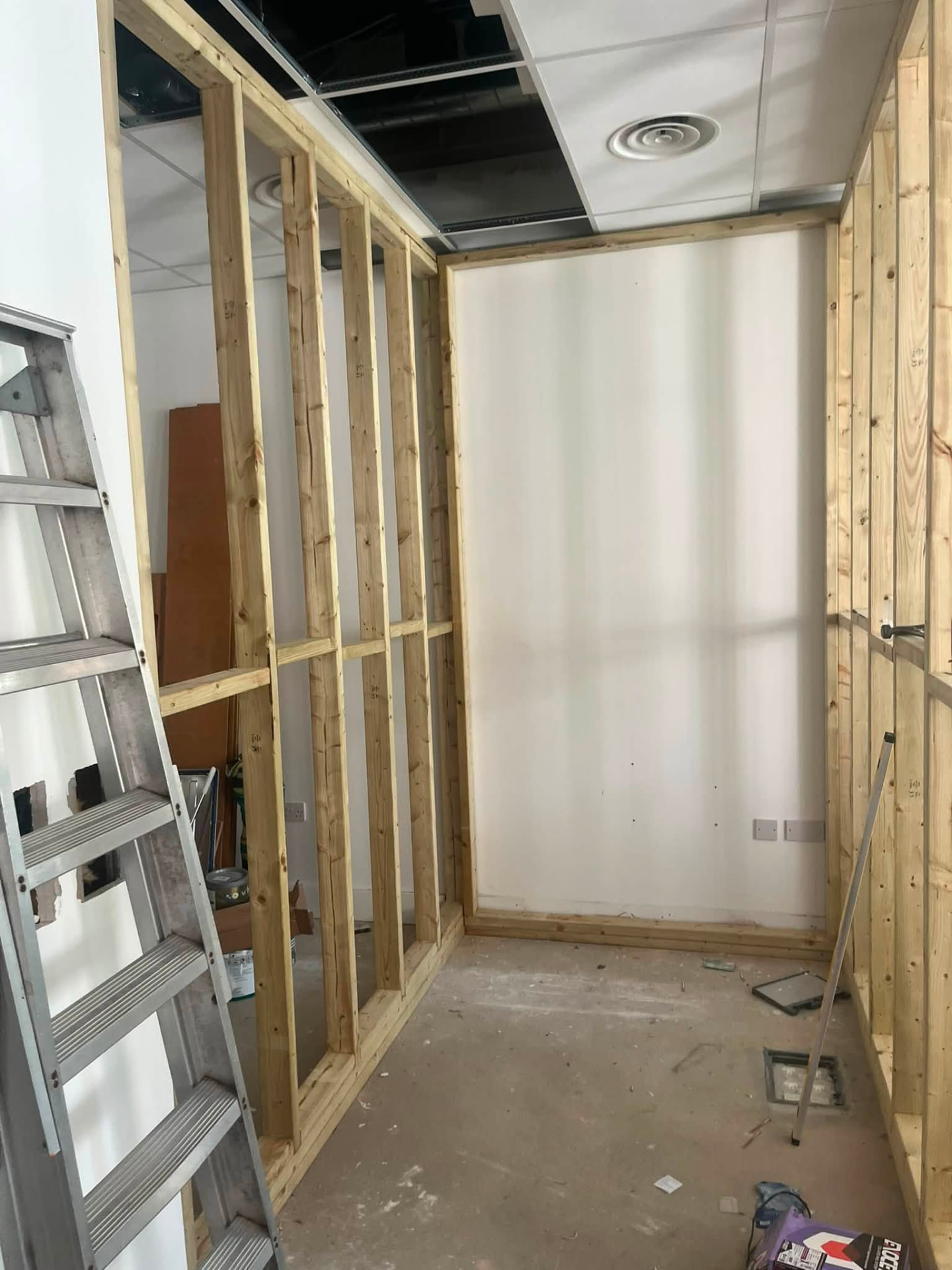 Stud partitions forming a new room with boarded return wall