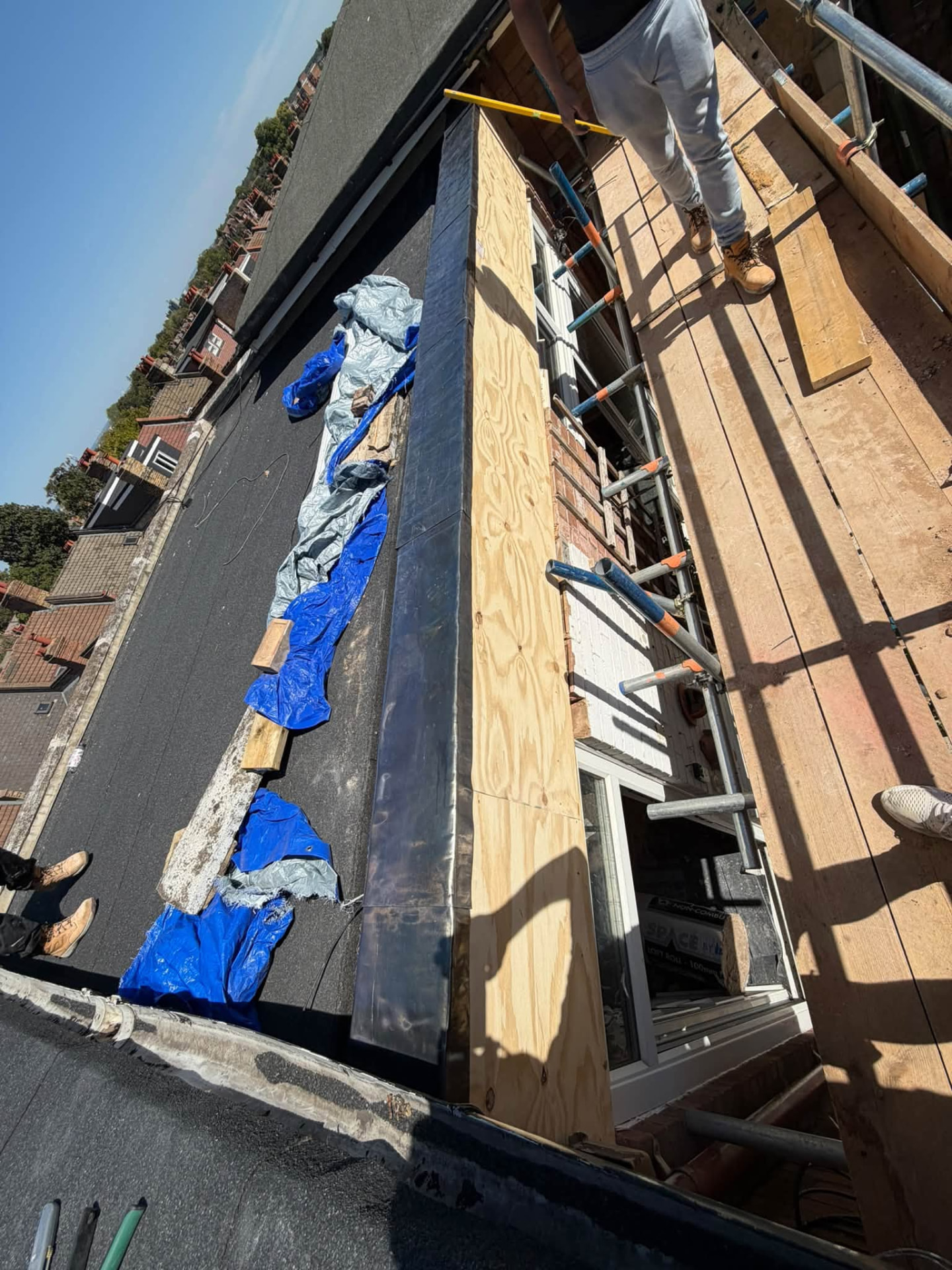 New cladding and leadwork checked for level from the scaffold