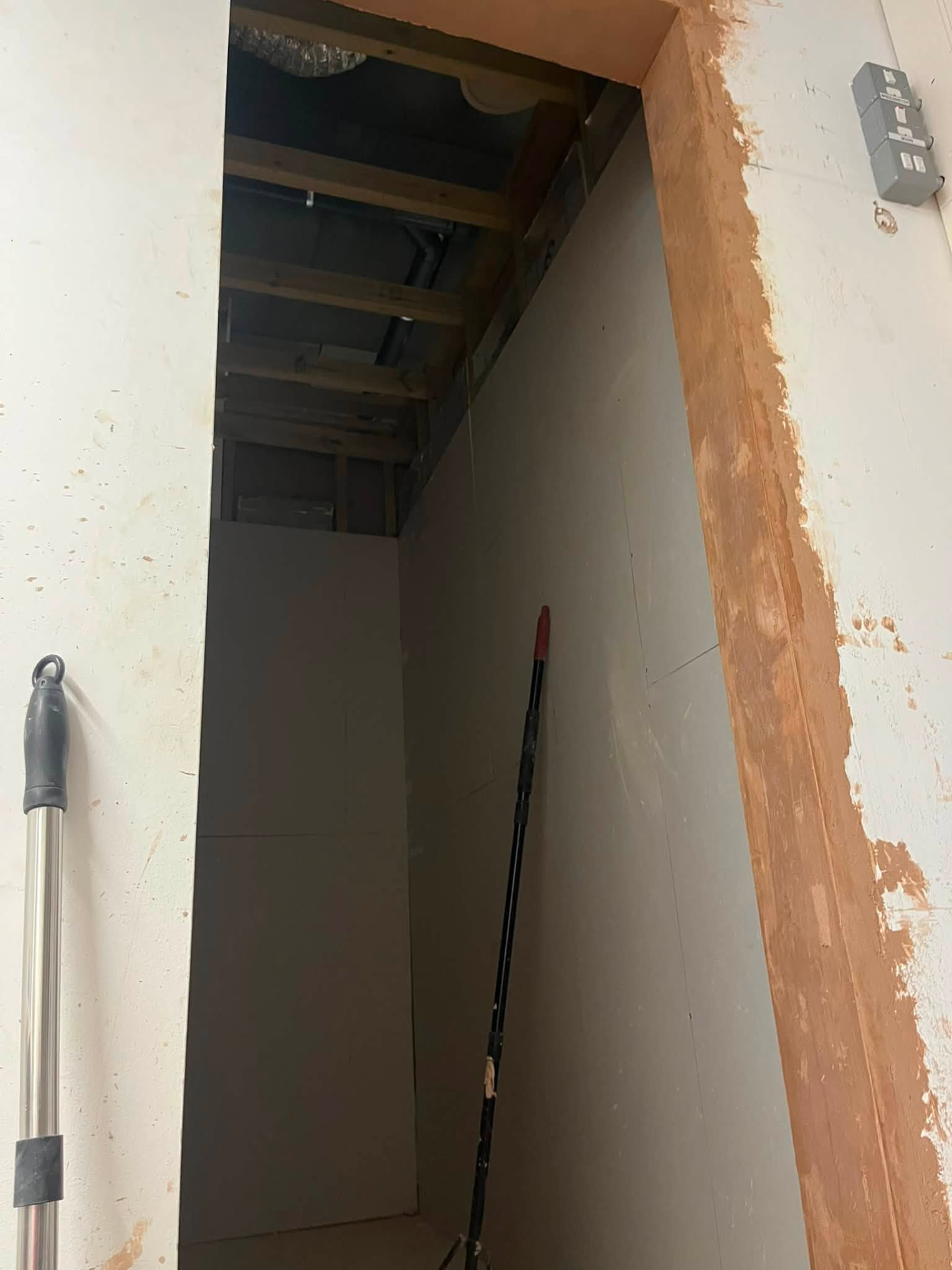 Finished opening through to the boarded corridor with plastered reveals