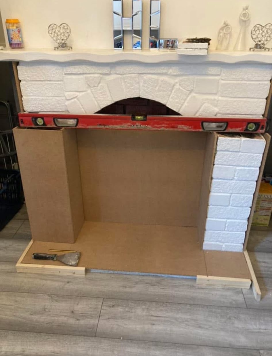 Fireplace cladding levelled and checked with a spirit level