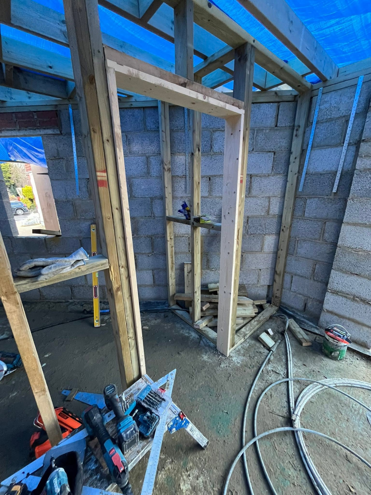 Timber door frame fitted between the framed partitions