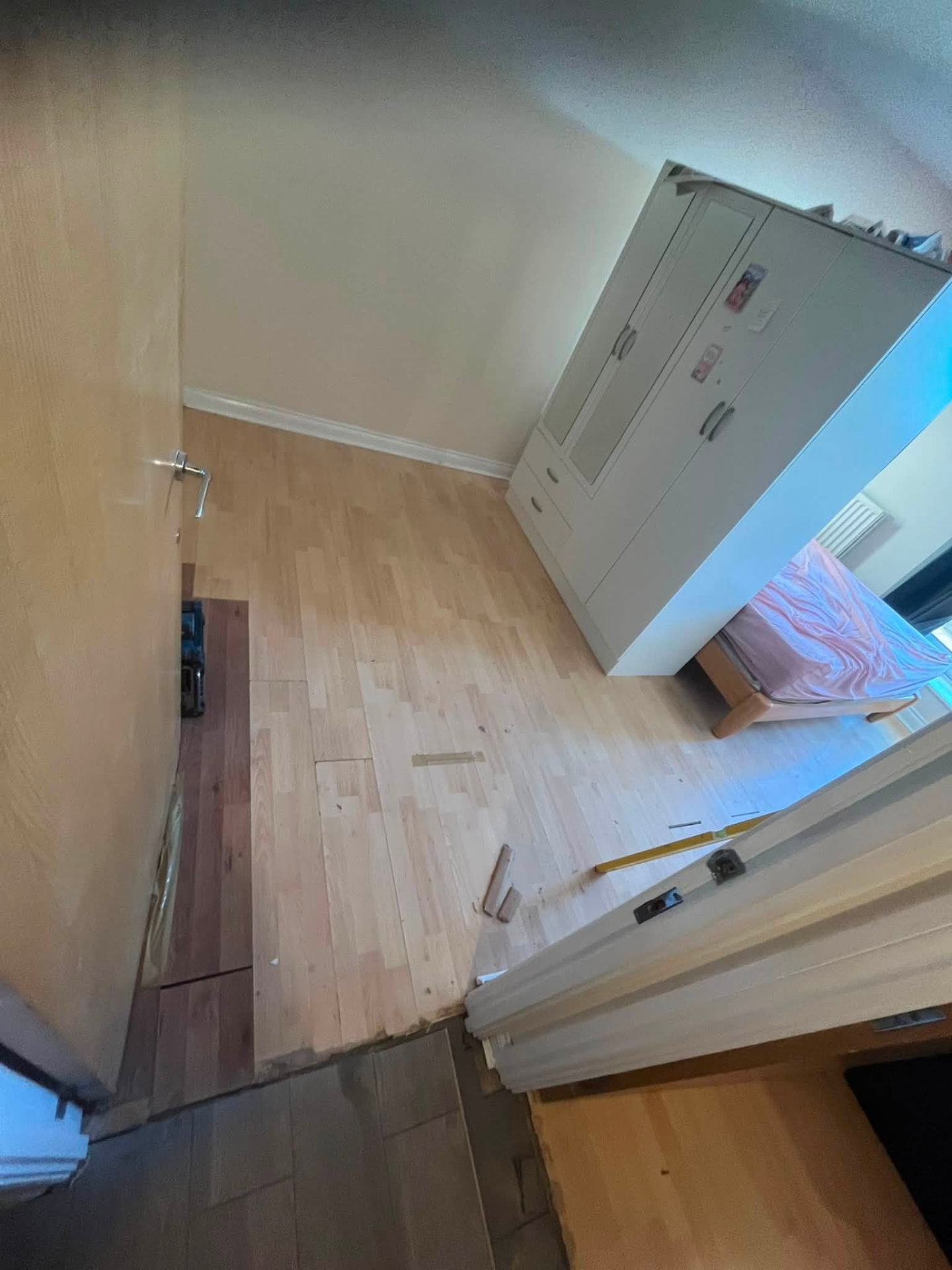 Adjoining room flooring lifted where the water had spread from the leak
