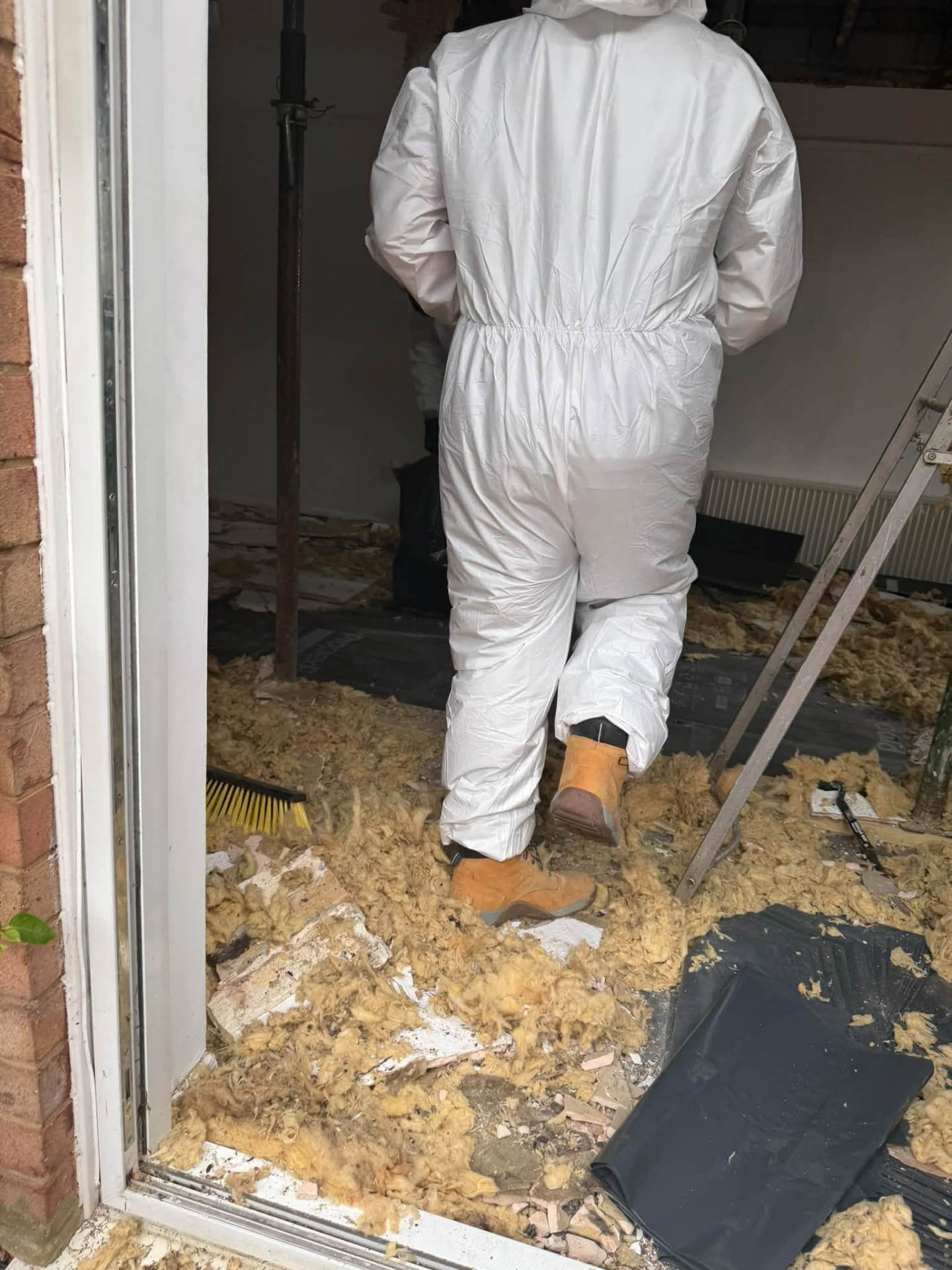 Old insulation and debris being cleared from the property during the strip-out