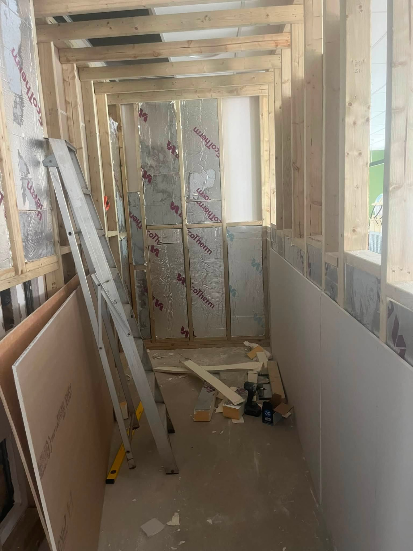 Insulated and part boarded corridor walls during the refurbishment
