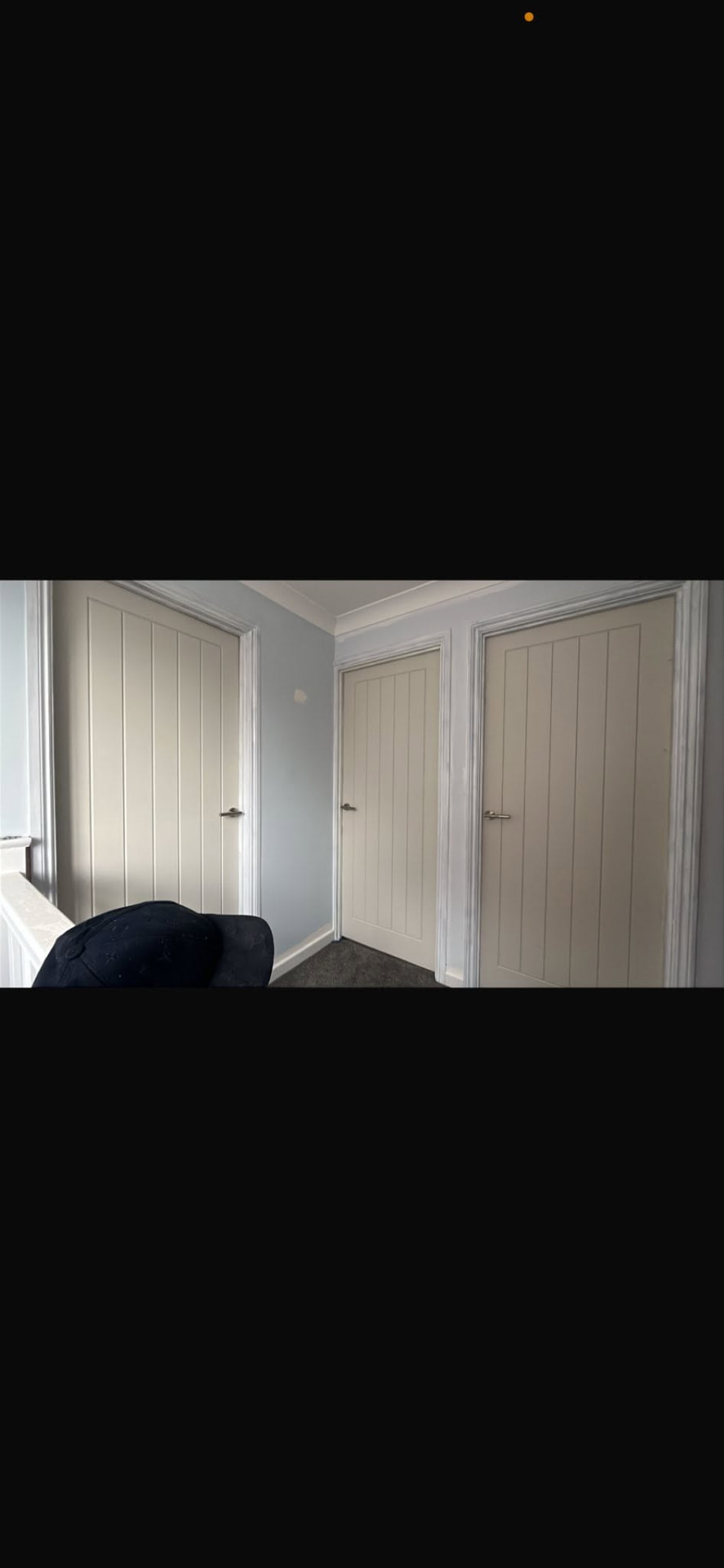Three freshly fitted white cottage doors across the landing