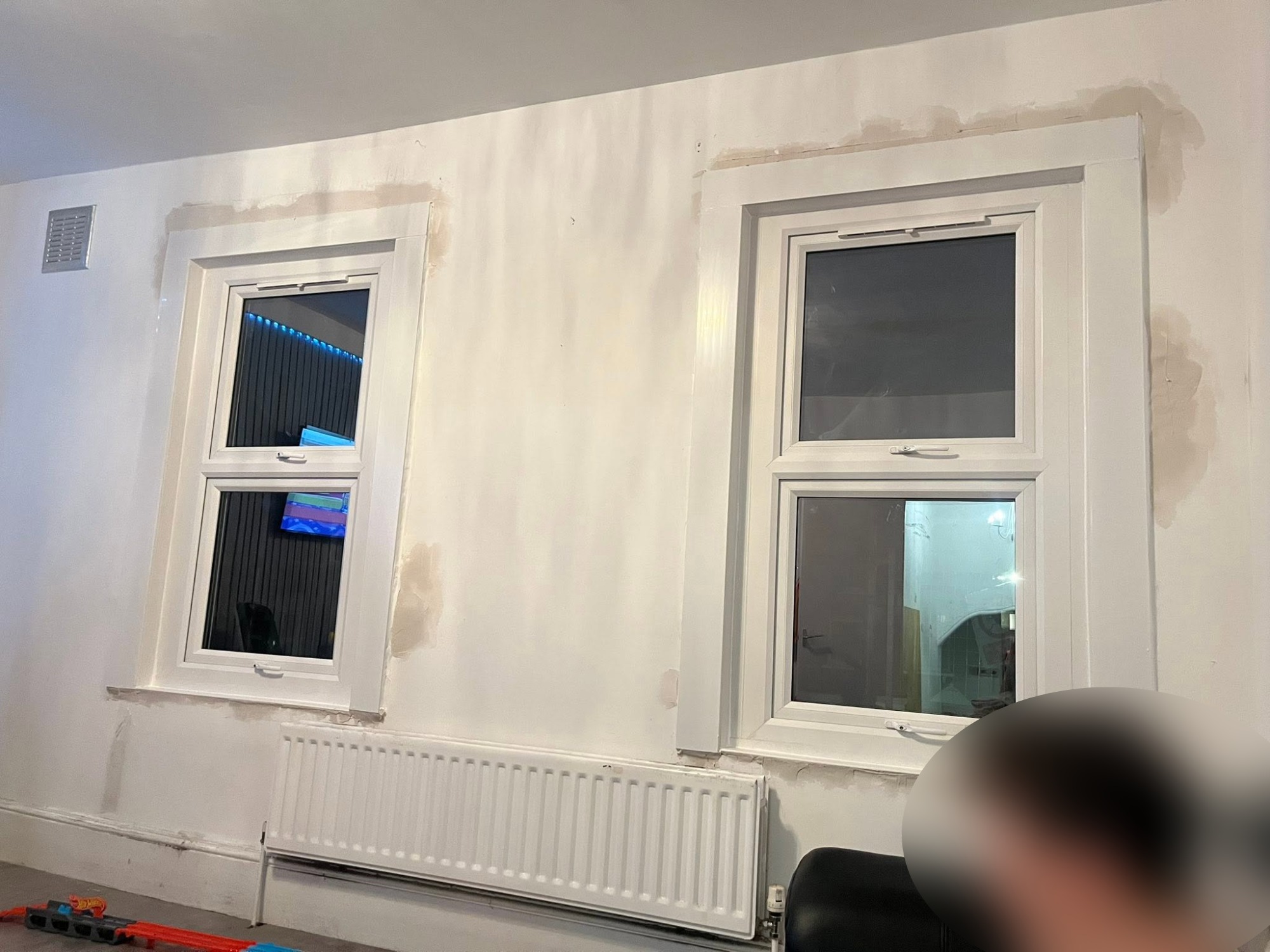 Both new uPVC double-glazed windows fitted with reveals made good and painted