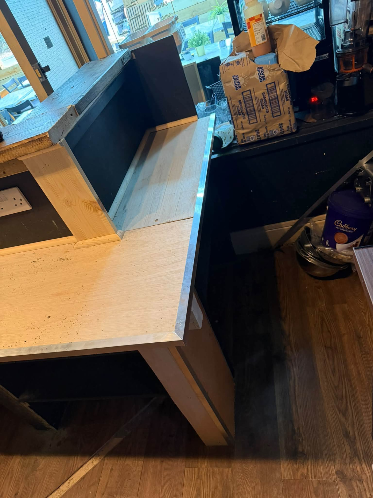 New counter carcass built up with light oak-effect panels and metal trim