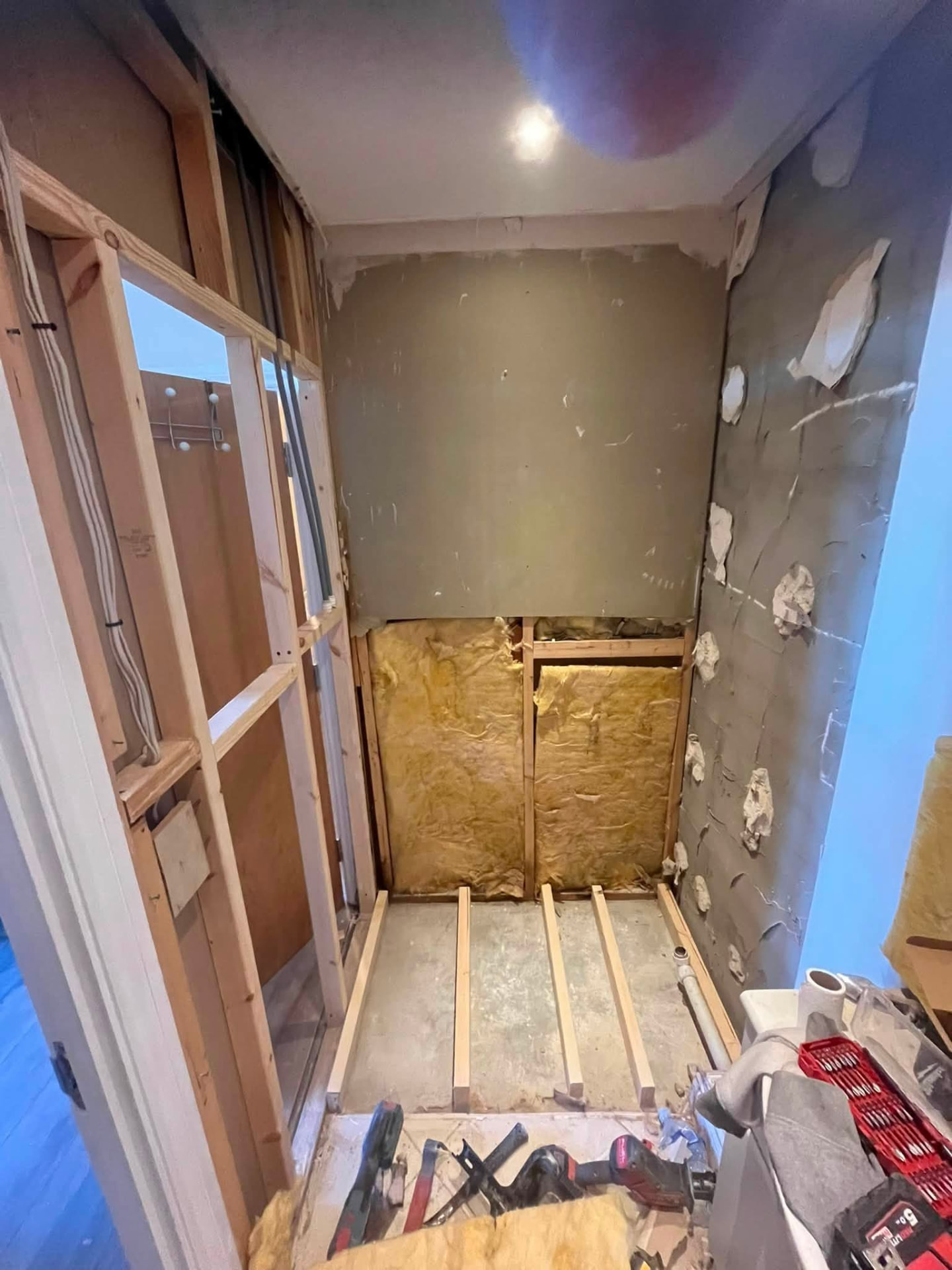 Shower cubicle rebuilt in timber studwork with fresh insulation installed