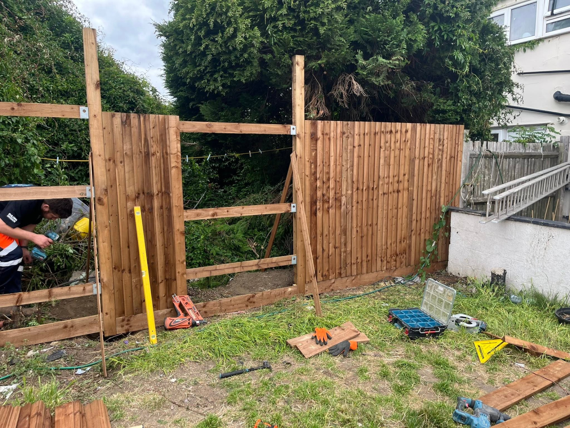 New posts and rails fixed in place with panels being levelled