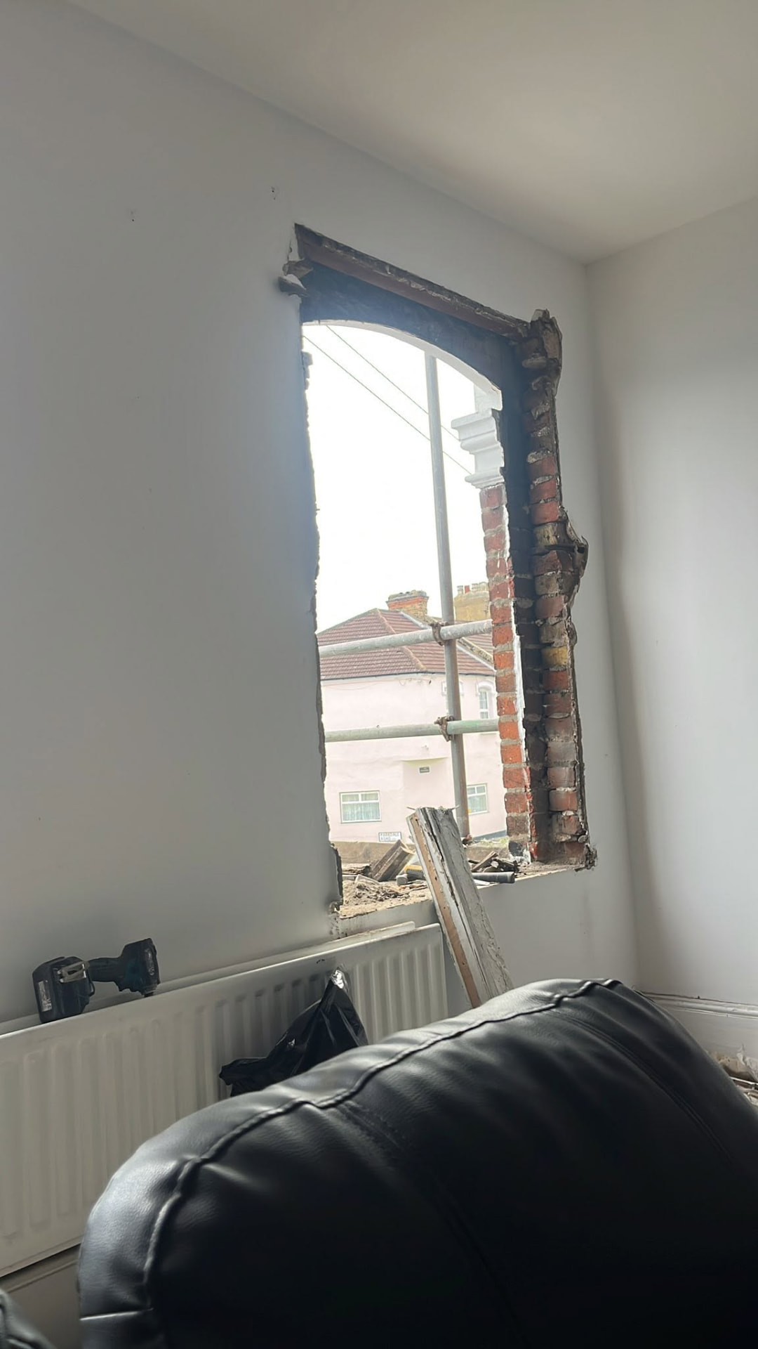 Second old sash window stripped out showing exposed brickwork reveals