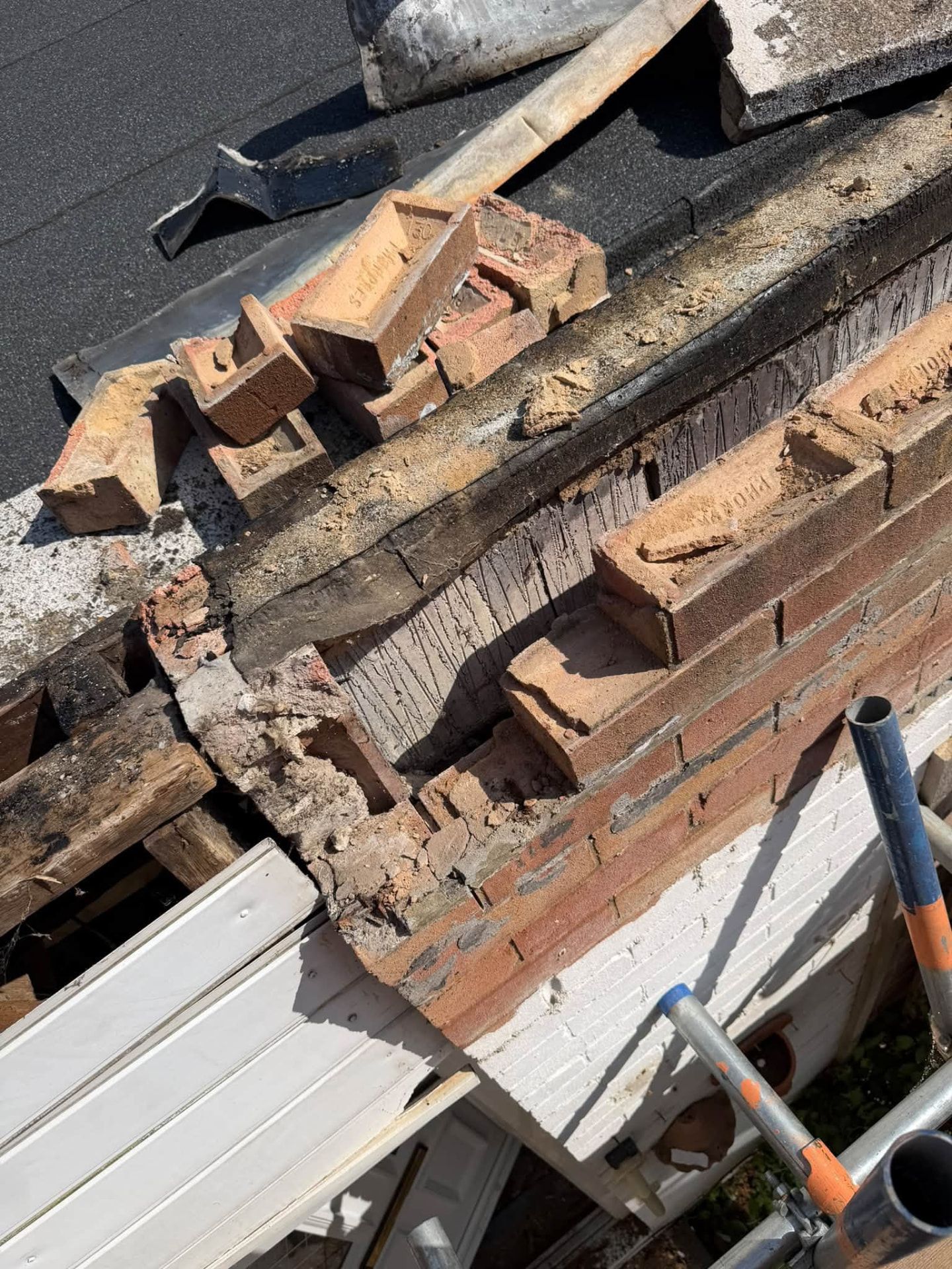 Damaged brickwork and broken timber removed during structural opening repair