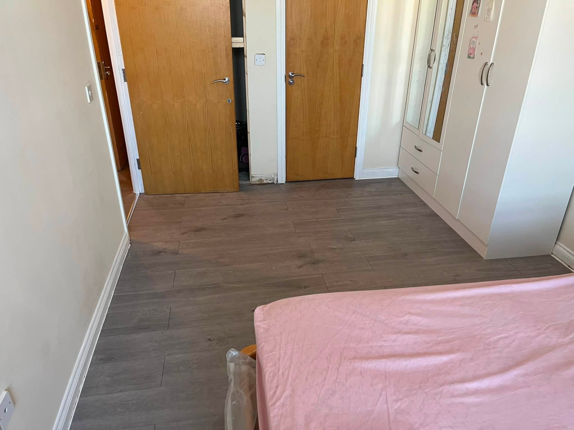 Bedroom floor completed with clean transitions at the doorways
