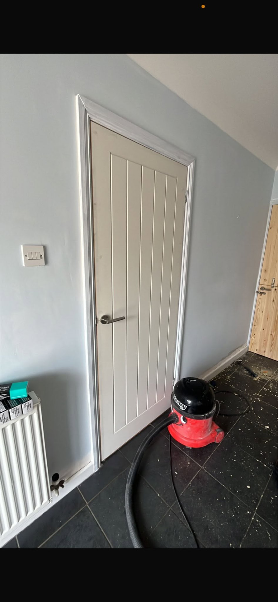 Freshly fitted white panelled door with new frame and ironmongery