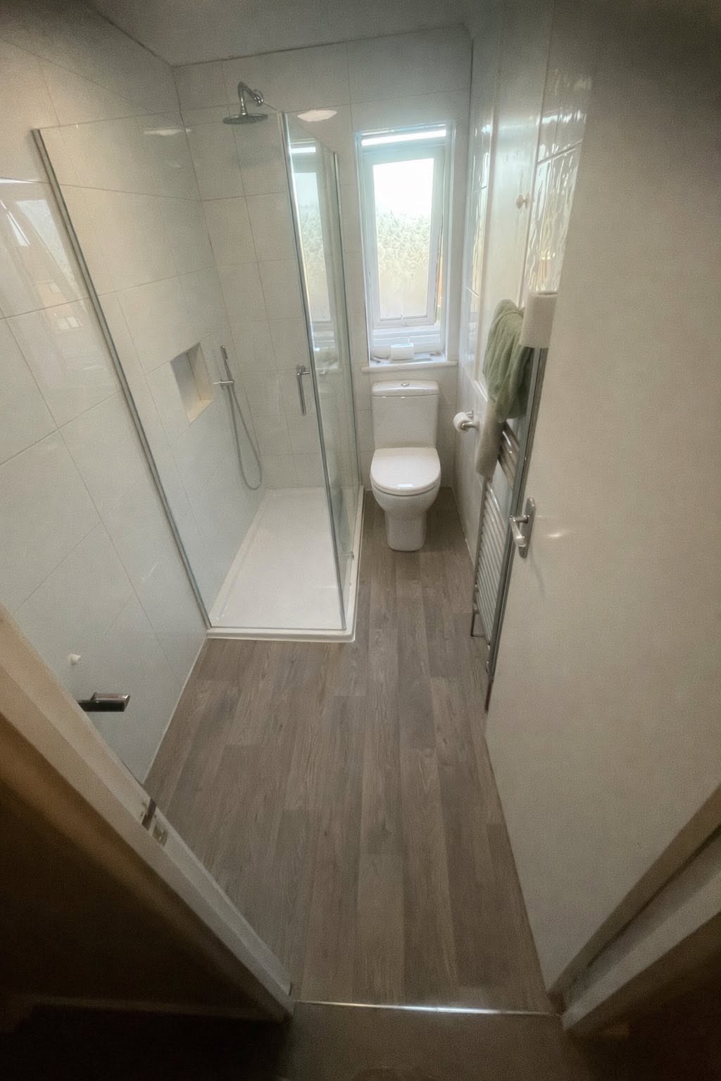 Completed modern bathroom with glass shower screen, new flooring and toilet suite
