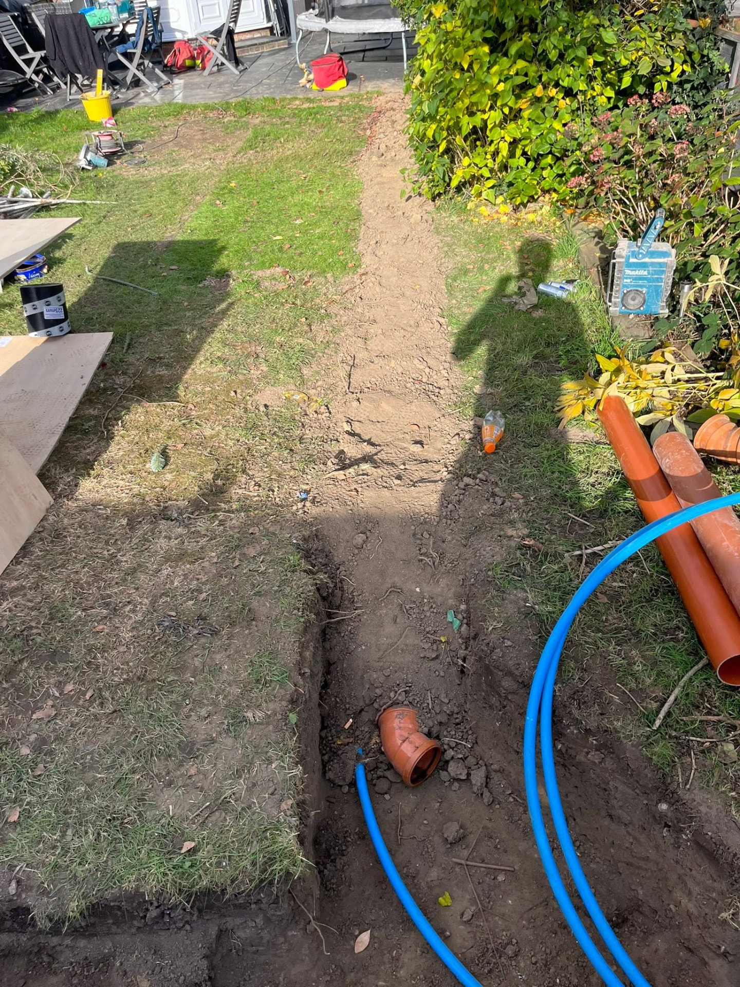 Completed drainage and water supply run with trenches backfilled and ground reinstated