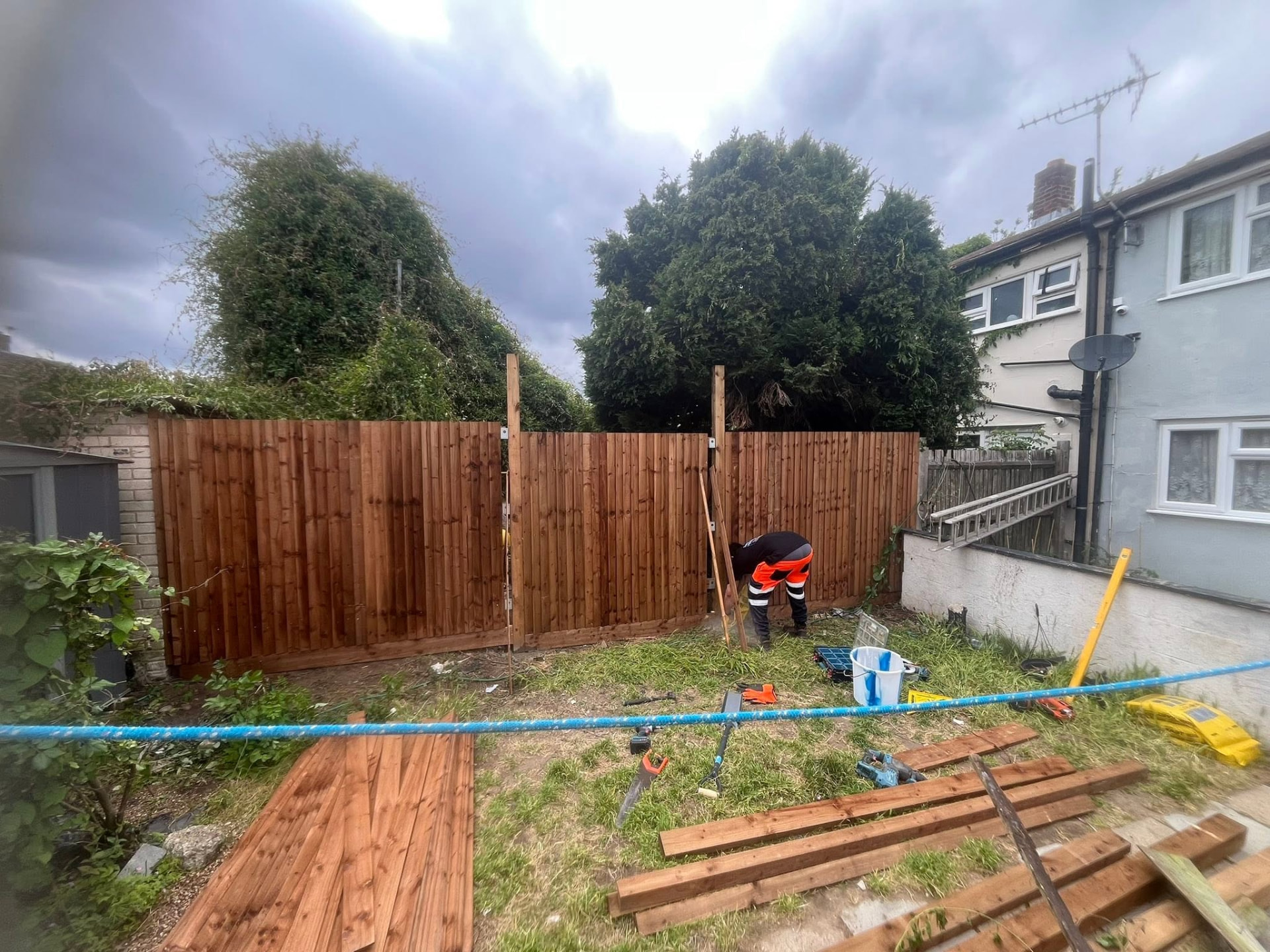 Run of new pressure-treated fencing installed across the garden