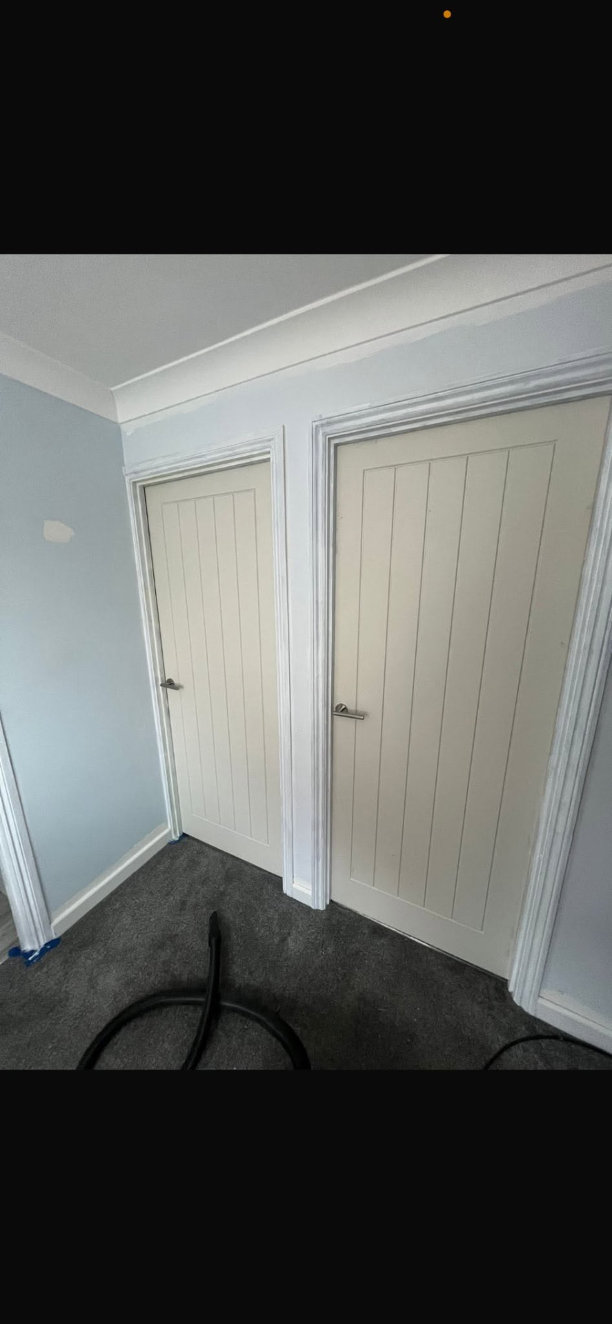 Two new white cottage-style doors fitted side by side on the landing